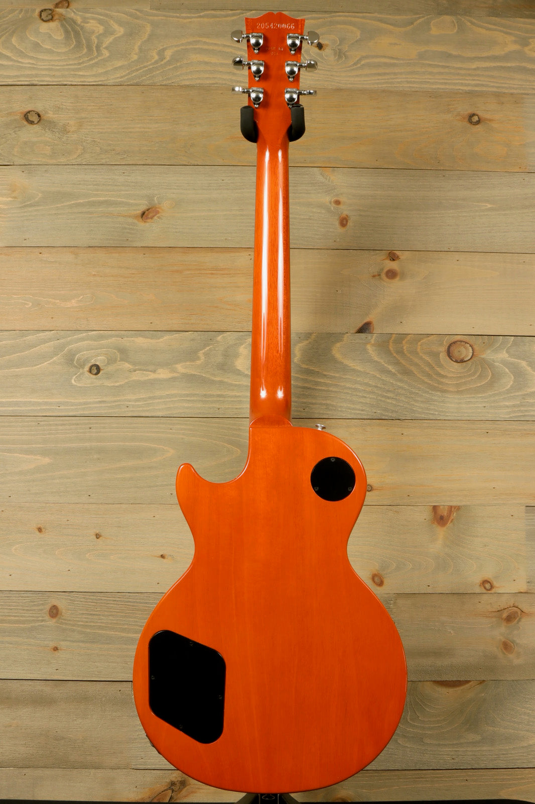 Gibson Les Paul Studio in vibrant orange finish, back view showcasing the body and hardware