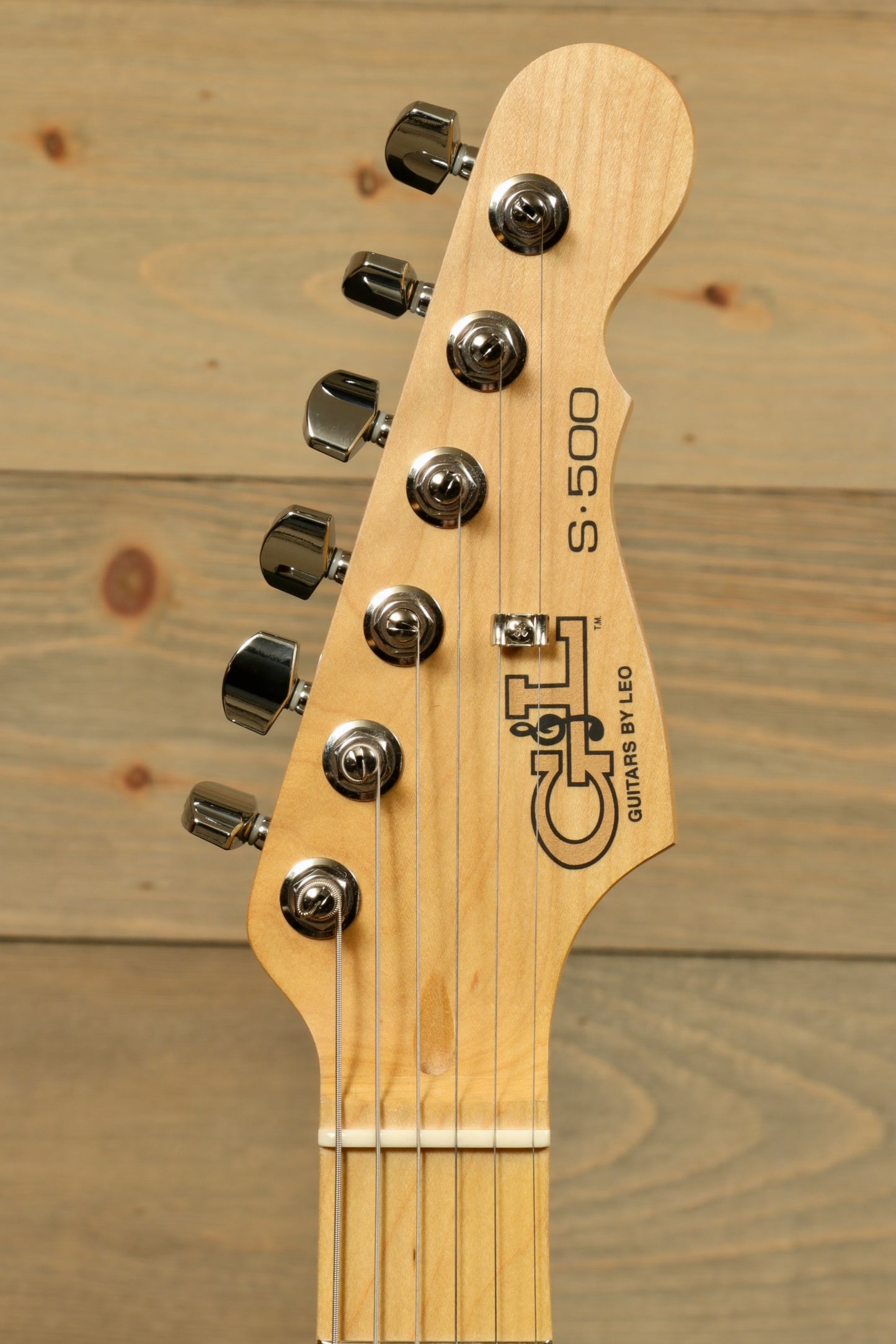 G&L S-500 Electric Guitar headstock in natural finish, showcasing tuning pegs and logo