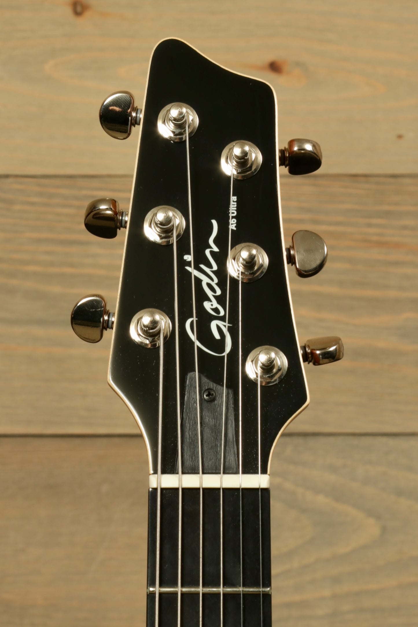 Godin A6 Ultra Denim Blue Flame with Gig Bag showcasing the headstock and tuning pegs