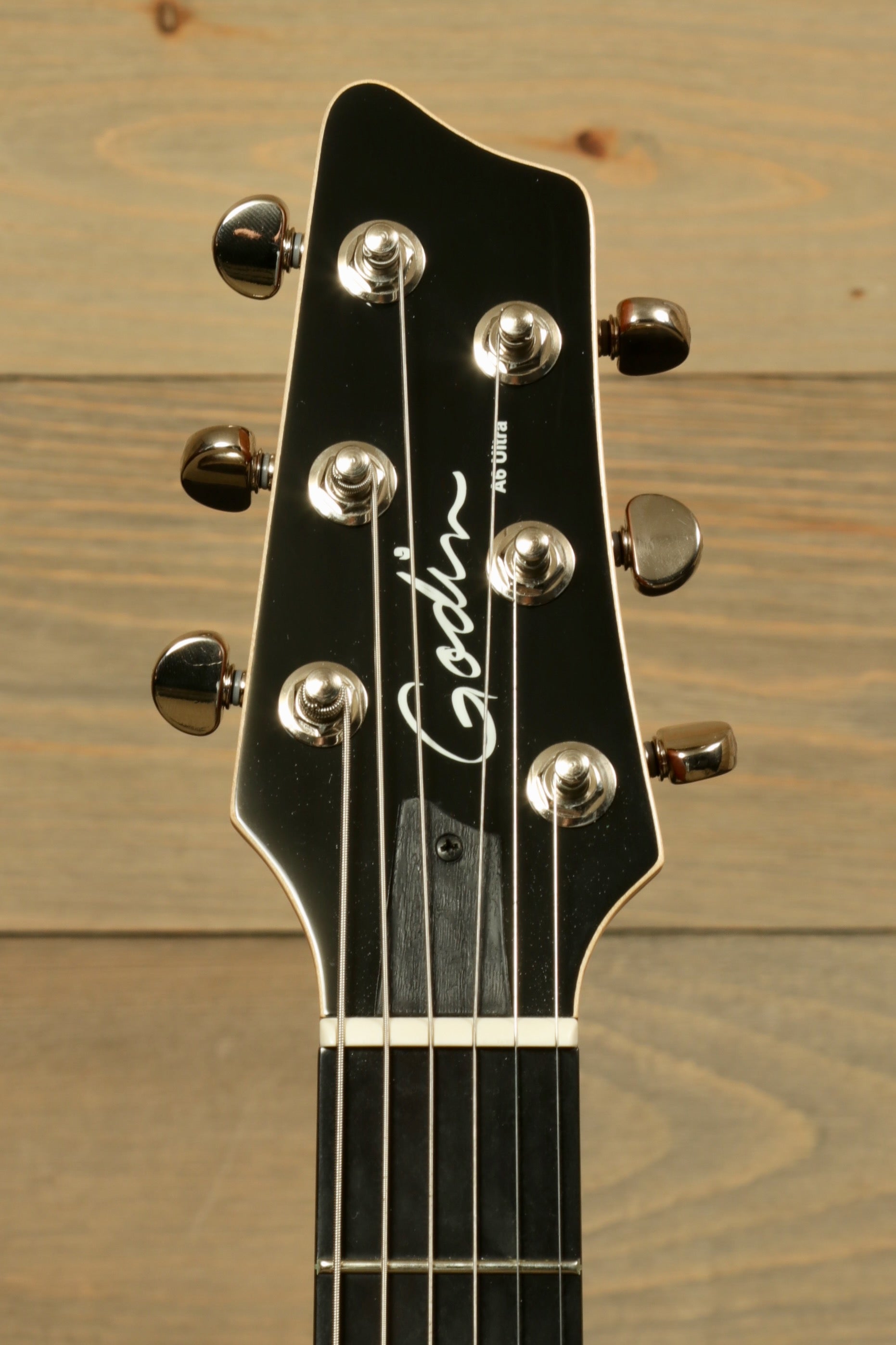 Godin A6 Ultra Denim Blue Flame with Gig Bag showcasing the headstock and tuning pegs