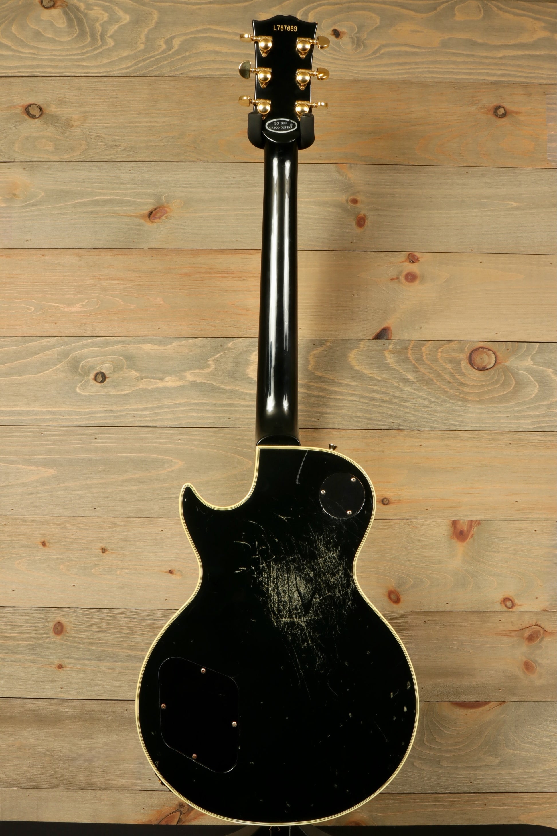 Greco guitar black finish, back view showcasing the unique wear and tear