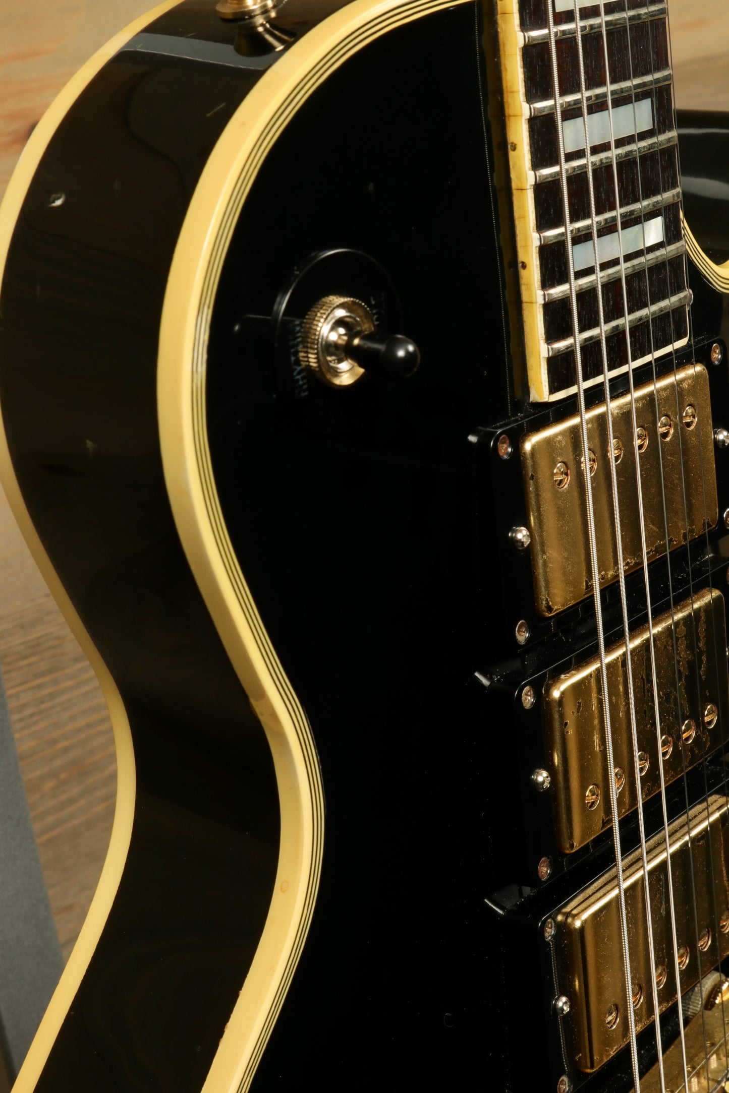 Greco guitar black finish with gold hardware, close-up side view highlighting the pickups