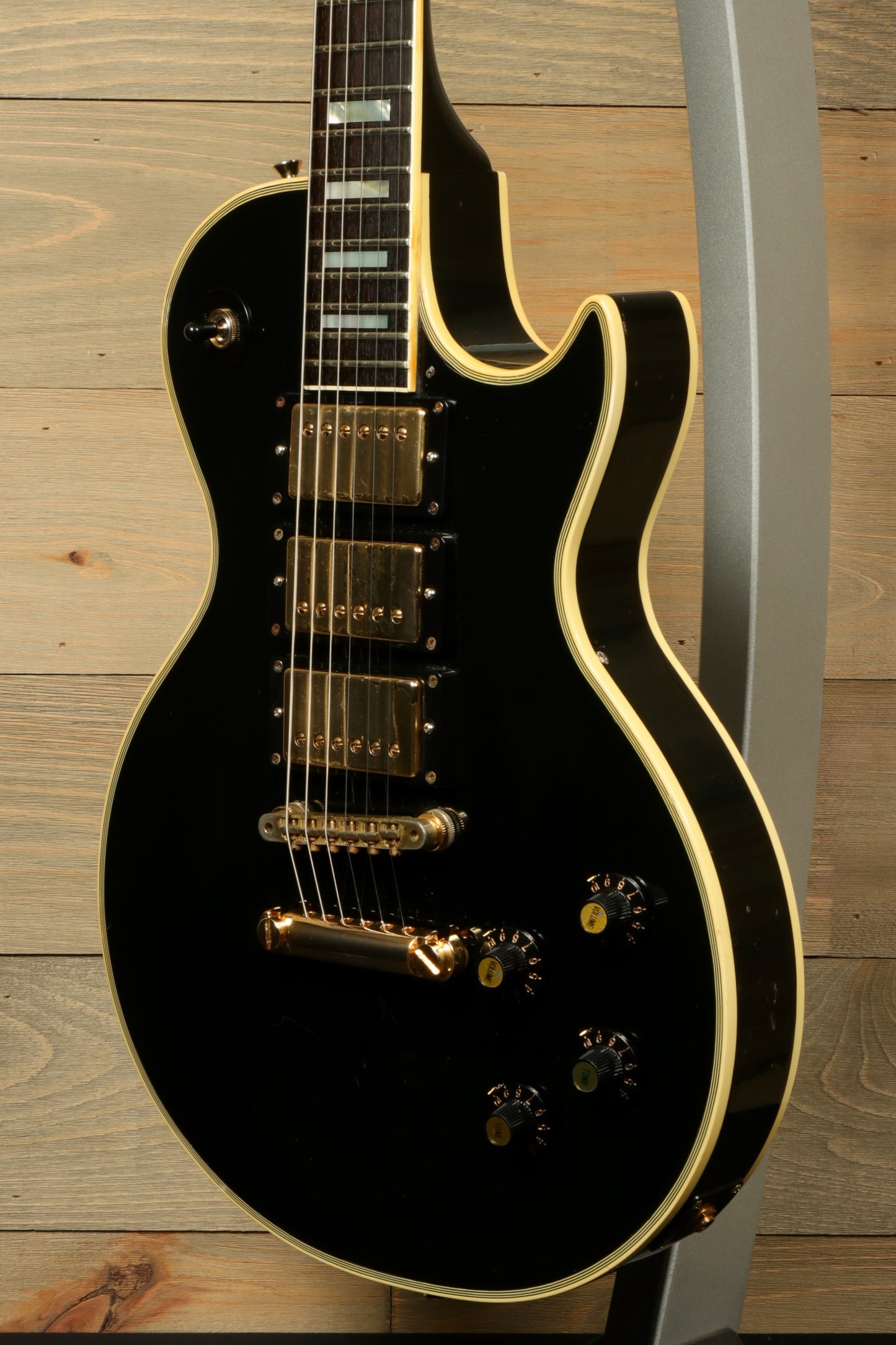 Greco guitar black electric model with gold hardware, side view