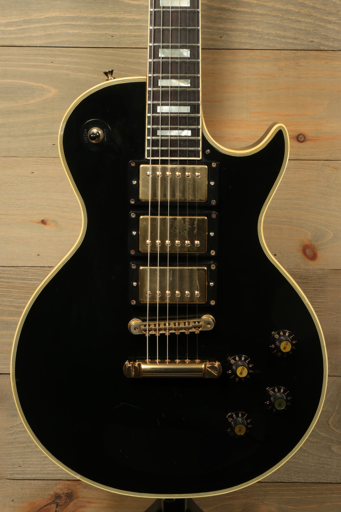 Greco guitar electric model in black finish, front view showcasing the body and hardware