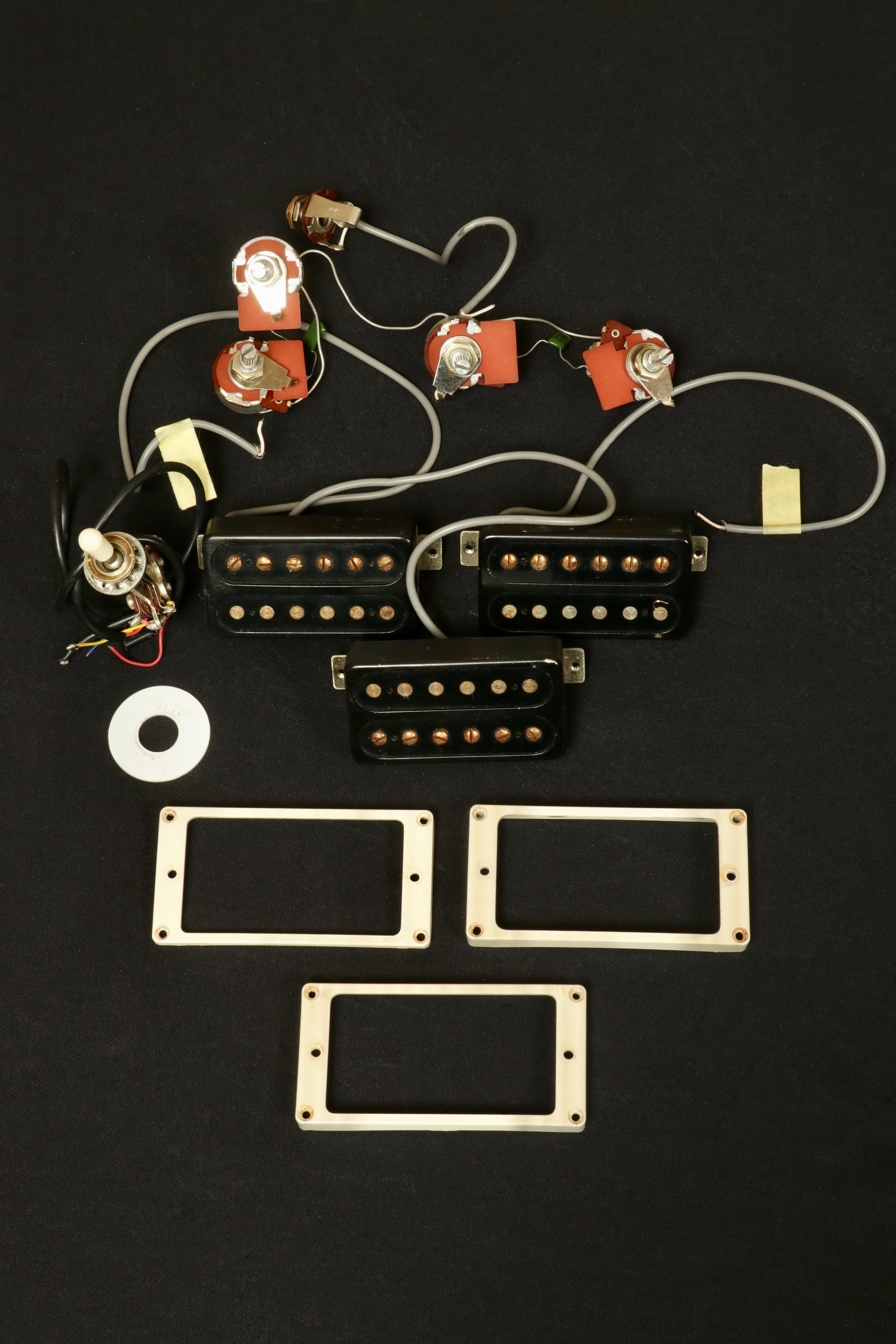Greco guitar electric guitar parts including pickups and control knobs, overhead view