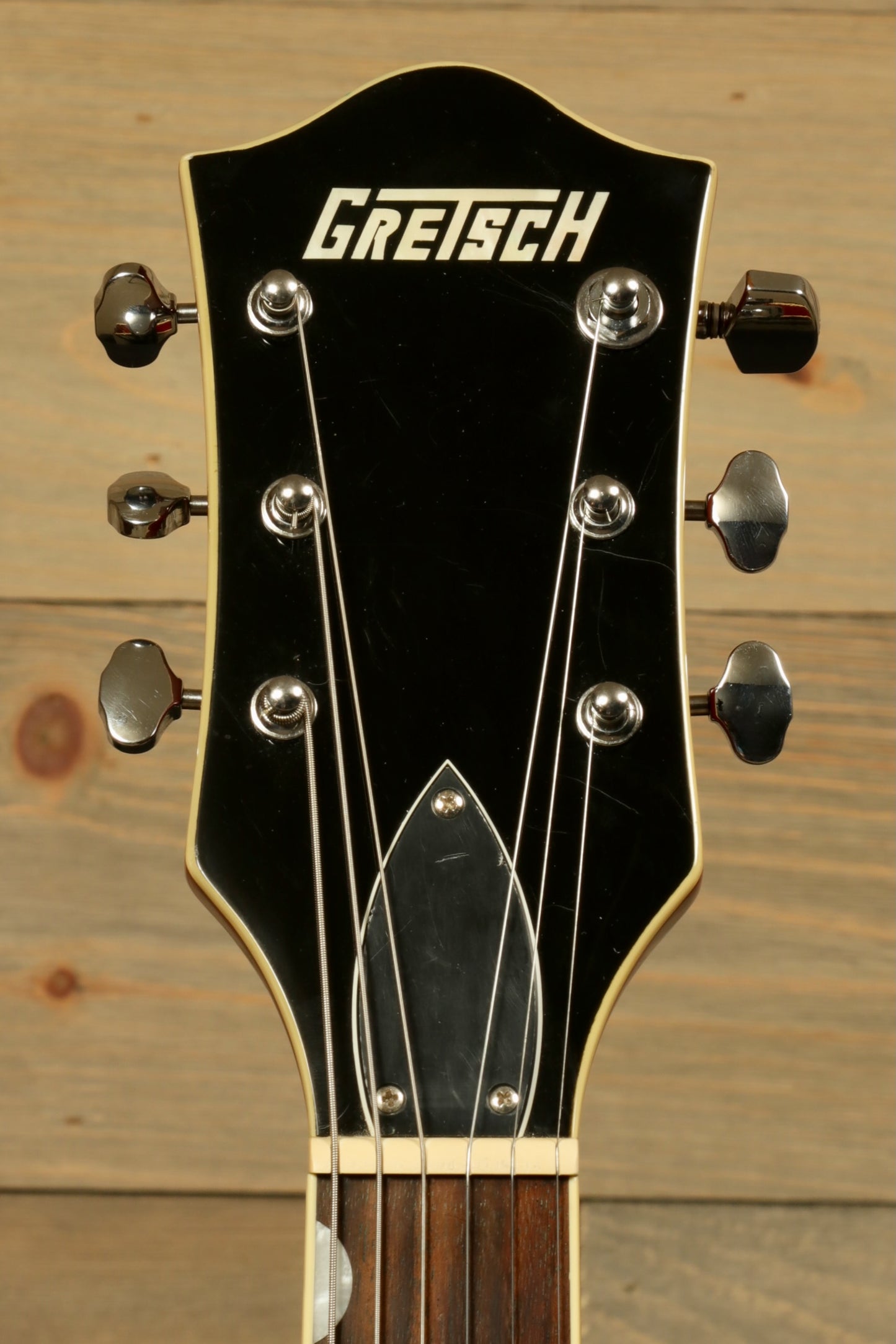 Gretsch G5420T Korea black headstock view with chrome tuning pegs and logo