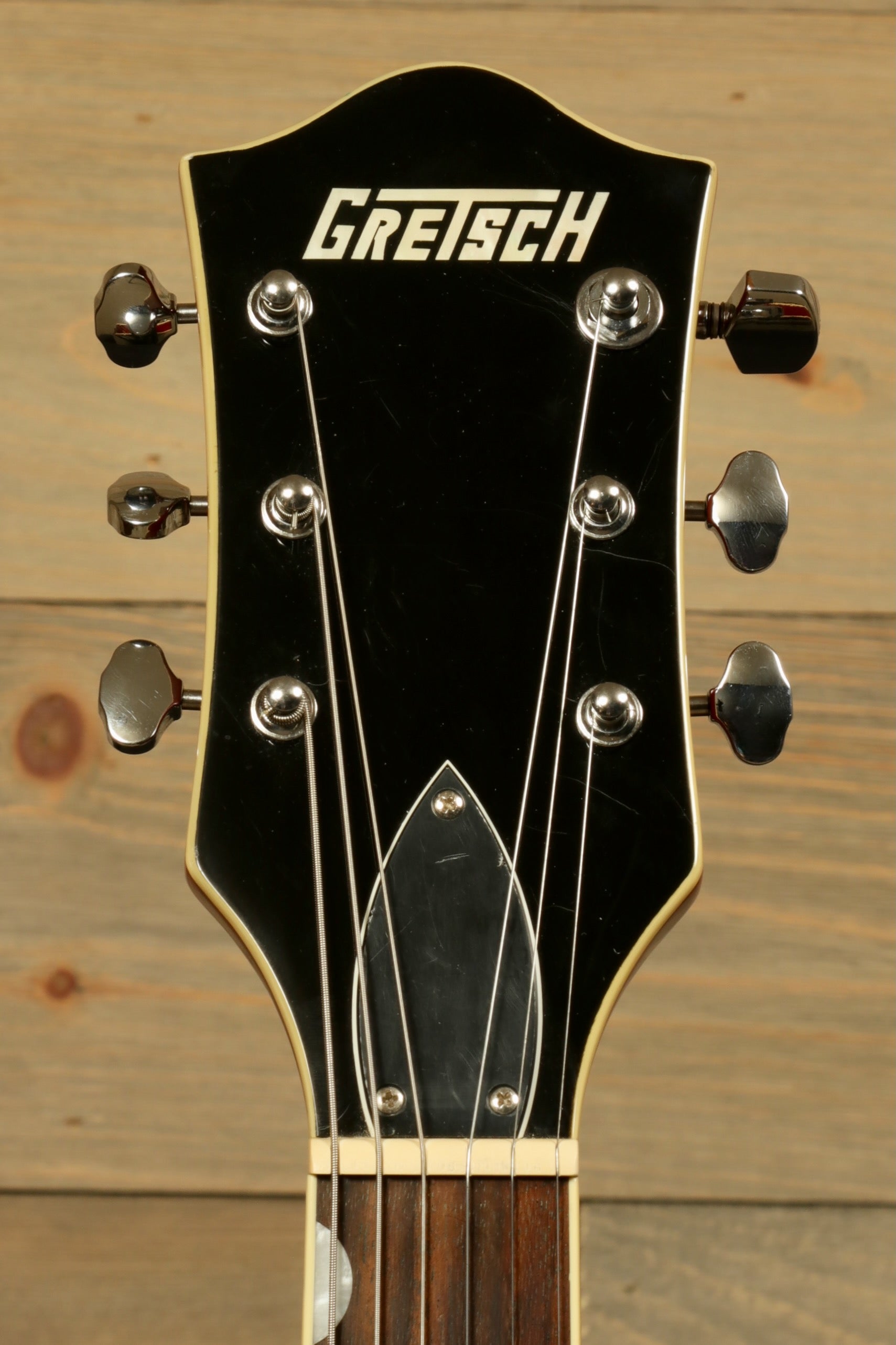 Gretsch G5420T Korea black headstock view with chrome tuning pegs and logo
