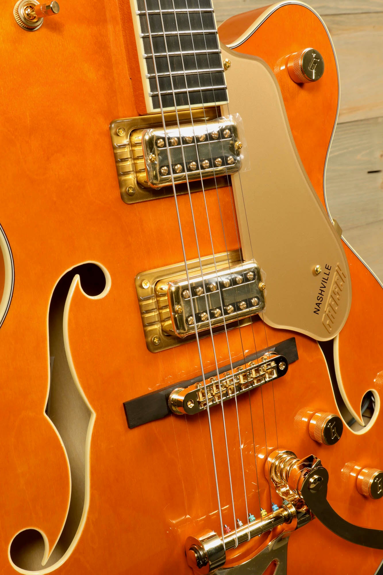 Gretsch Synchromatic Nashville hollow body guitar in vibrant orange with gold hardware and unique design