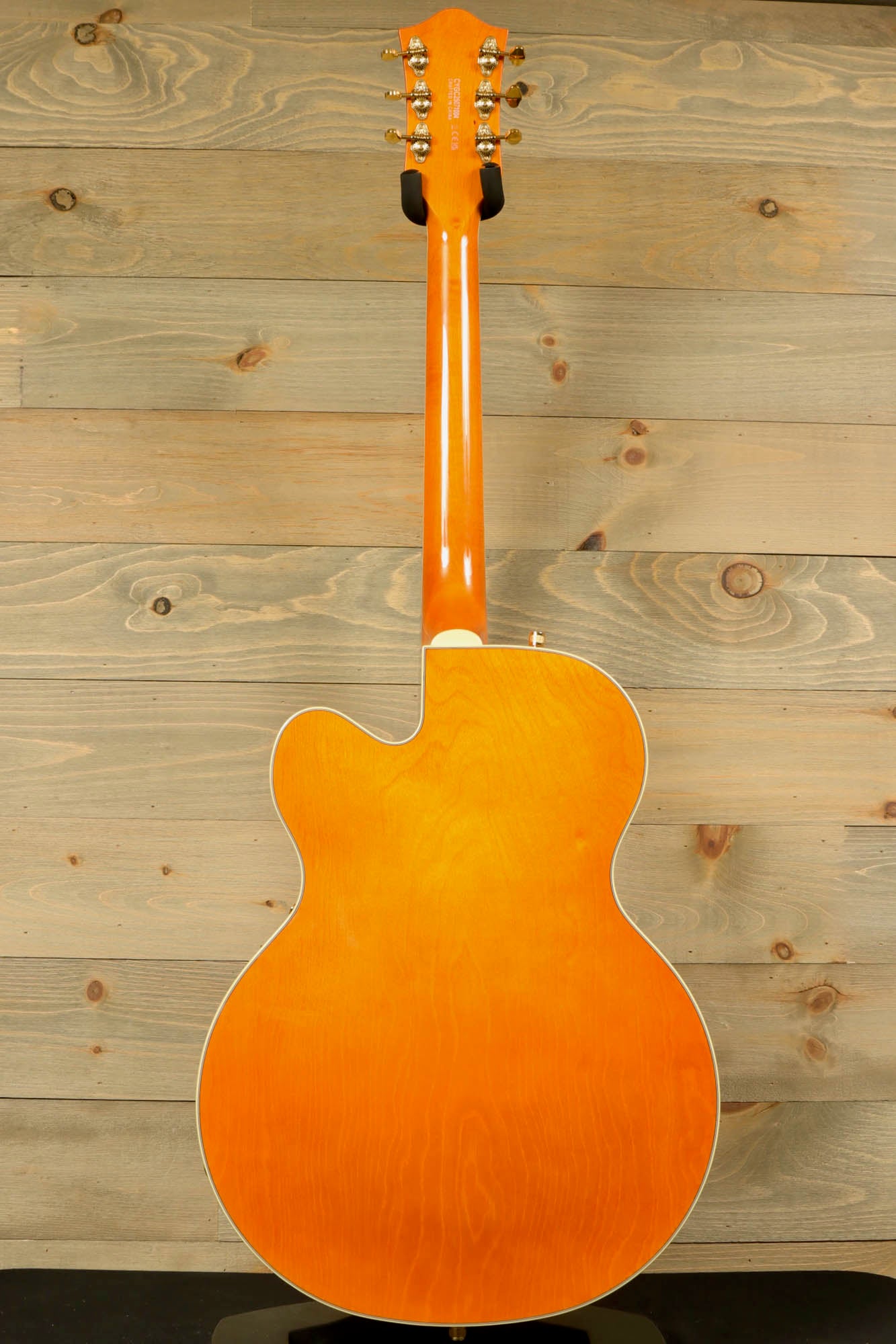 Back view of Gretsch Synchromatic Nashville hollow body guitar with a smooth, vibrant orange finish