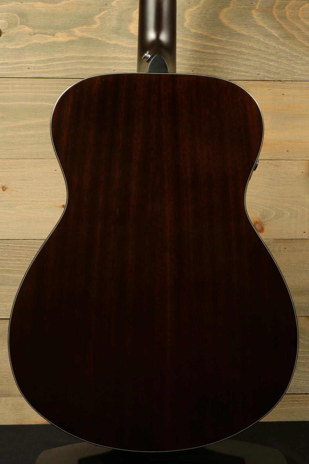 Yamaha acoustic electric guitar, dark wood finish, back view showcasing smooth contours