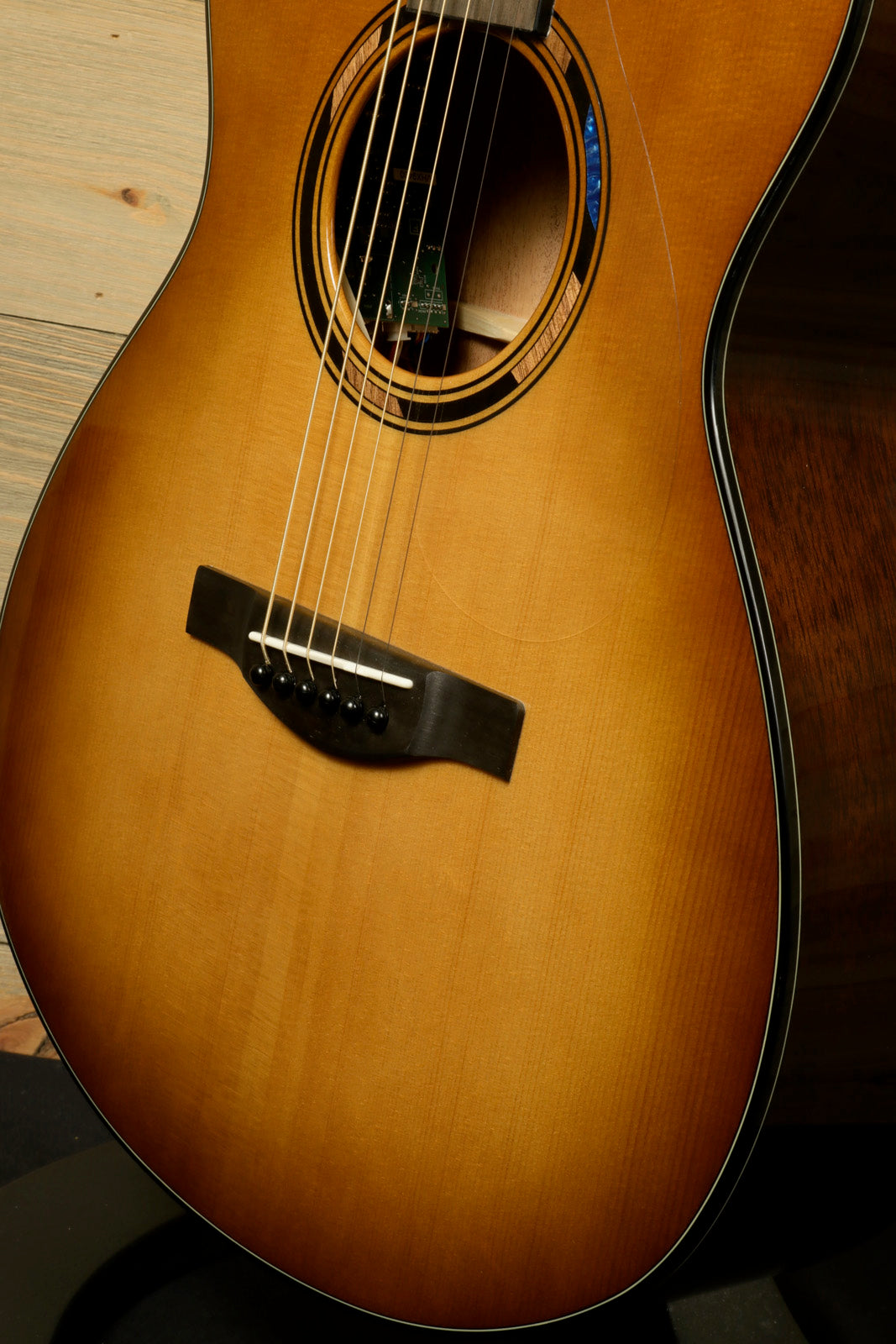 Yamaha acoustic electric guitar with a sunburst finish, showcasing the body and strings from a front view