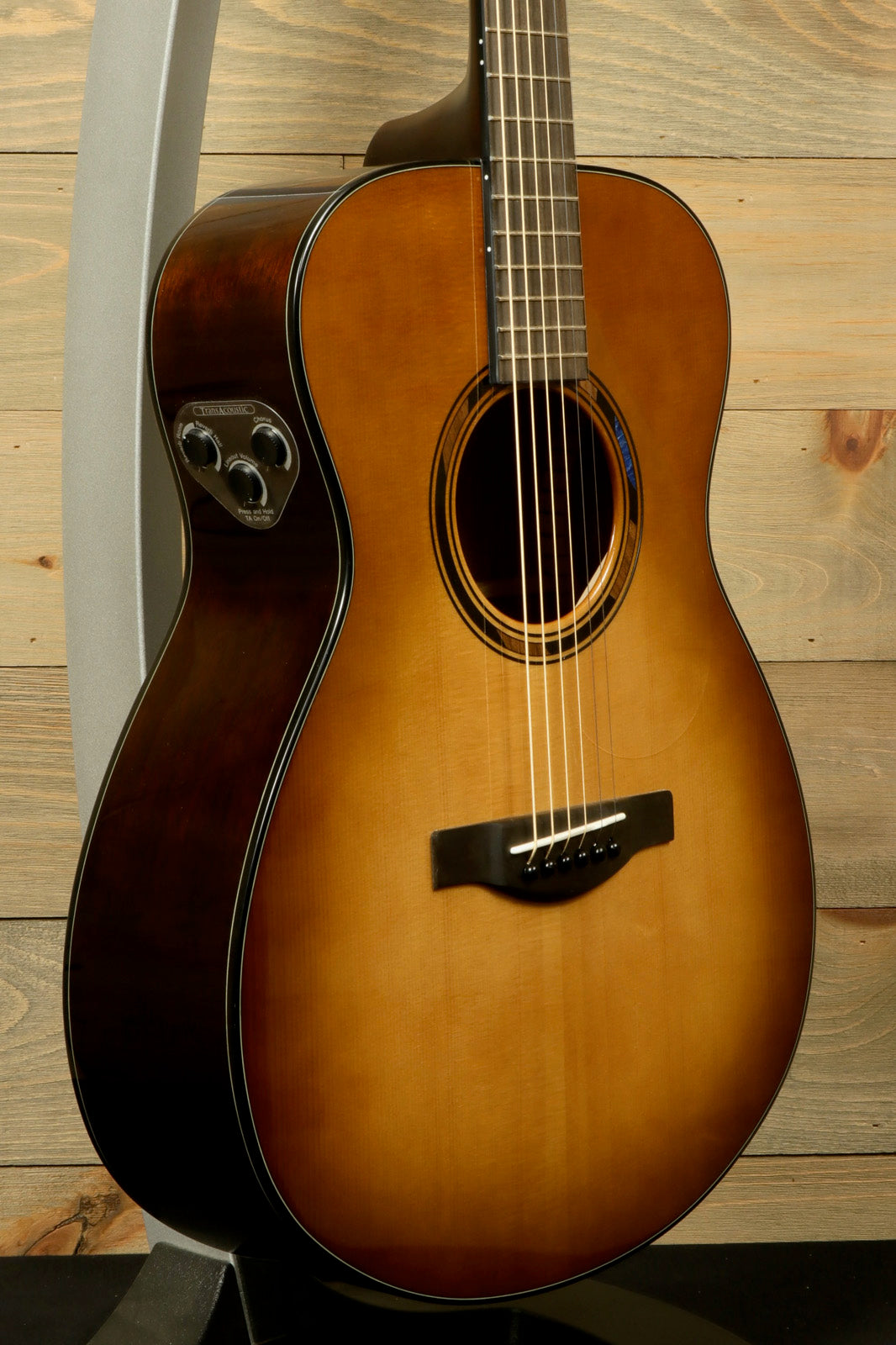 Yamaha acoustic electric guitar, sunburst finish, front view highlighting the body and controls