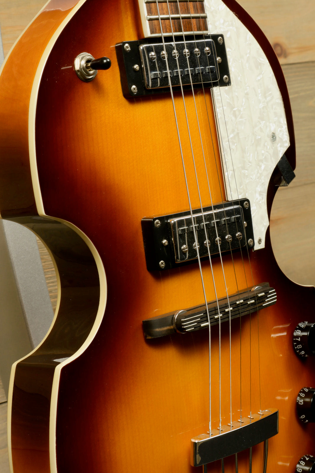 Hofner Guitar hollow body electric guitar in sunburst finish, side view showcasing pickups and controls