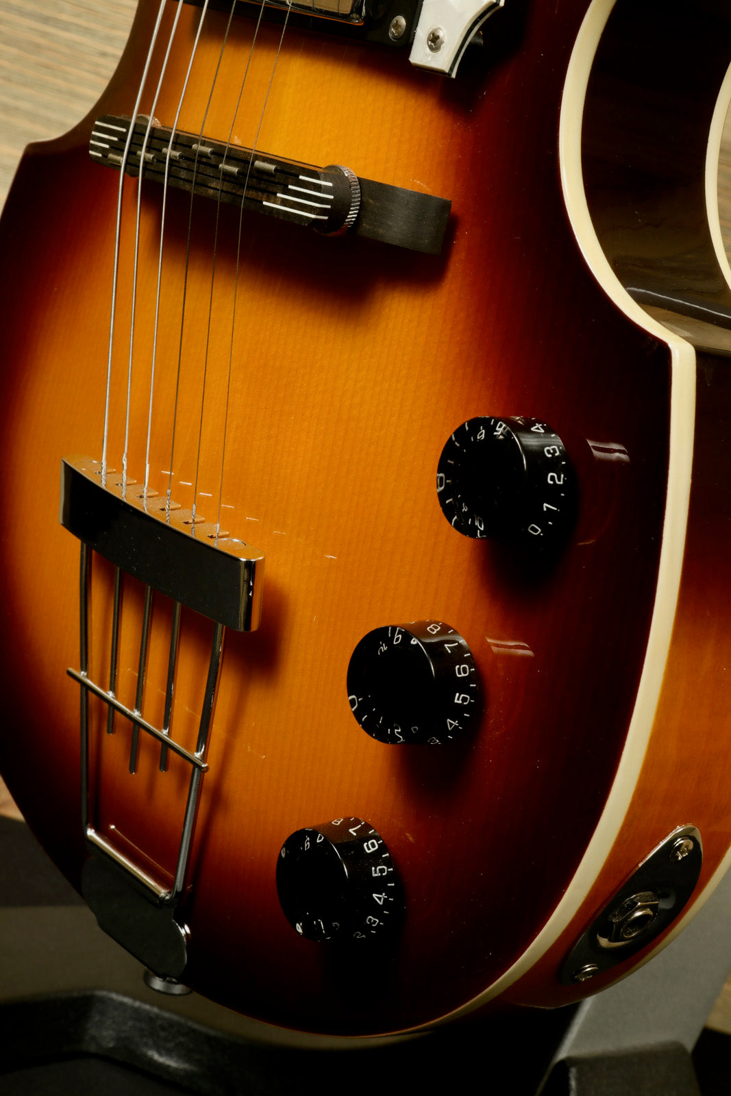 Hofner Guitar hollow body electric in sunburst finish, showcasing knobs and strings in close view
