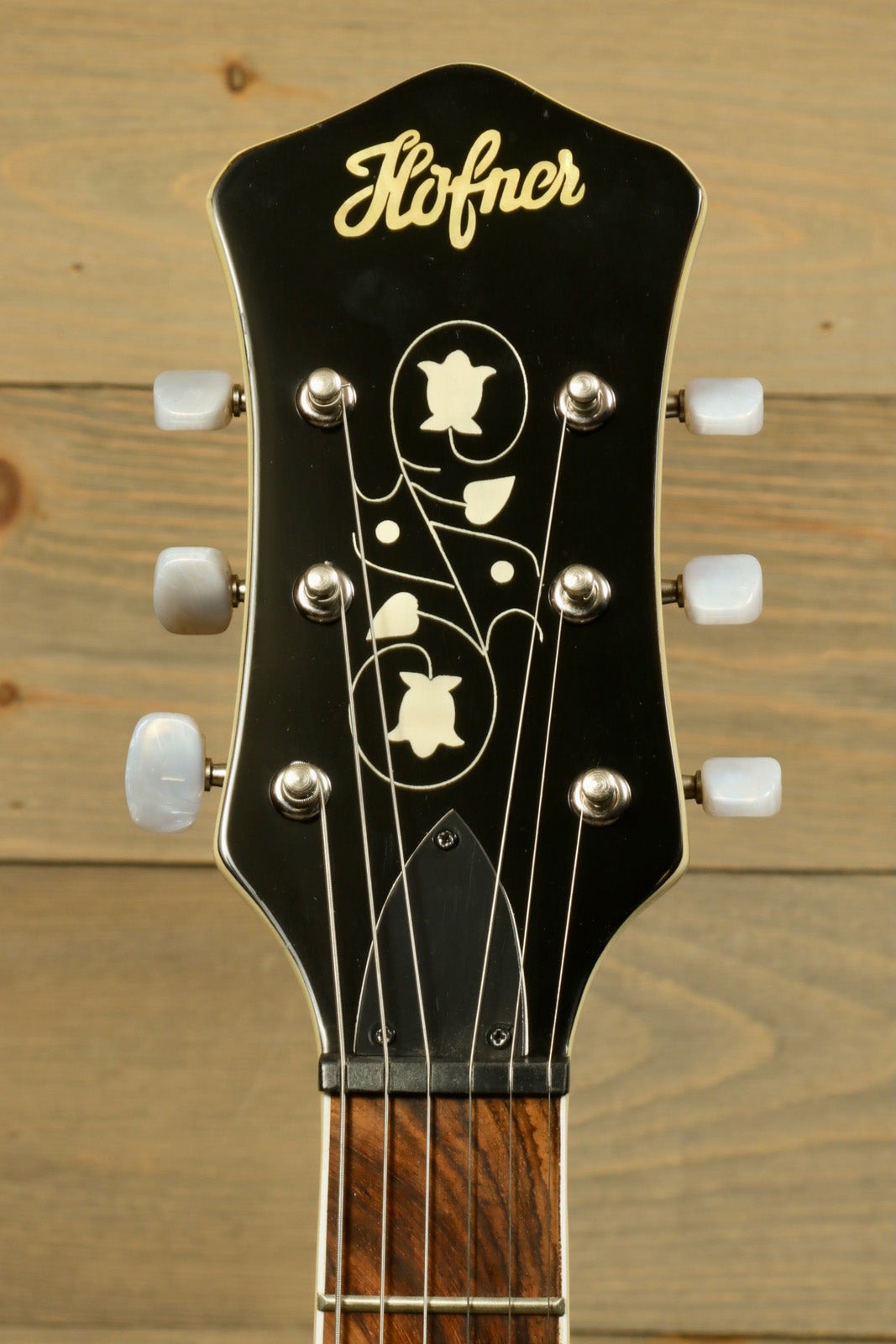 Hofner Guitar headstock with decorative inlays and chrome tuning pegs, front view
