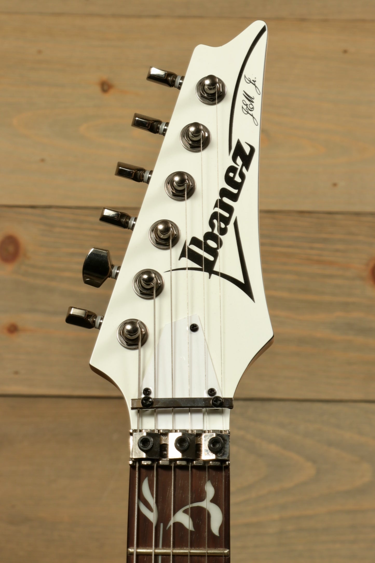 Ibanez JEMJR Steve Vai guitar, white finish, headstock view showcasing tuning pegs