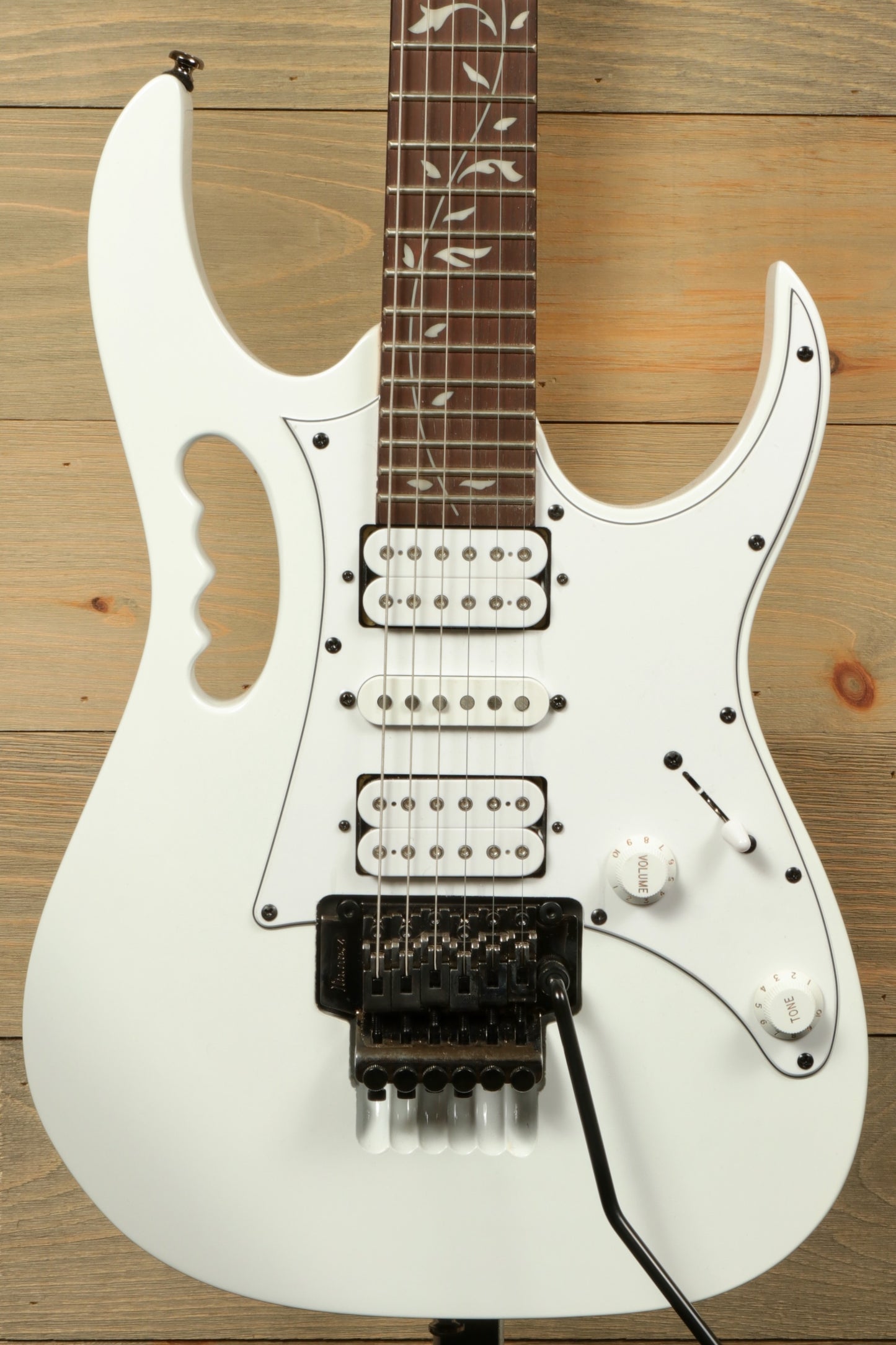 Ibanez JEMJR Steve Vai white electric guitar, front view with floral inlays and three pickups