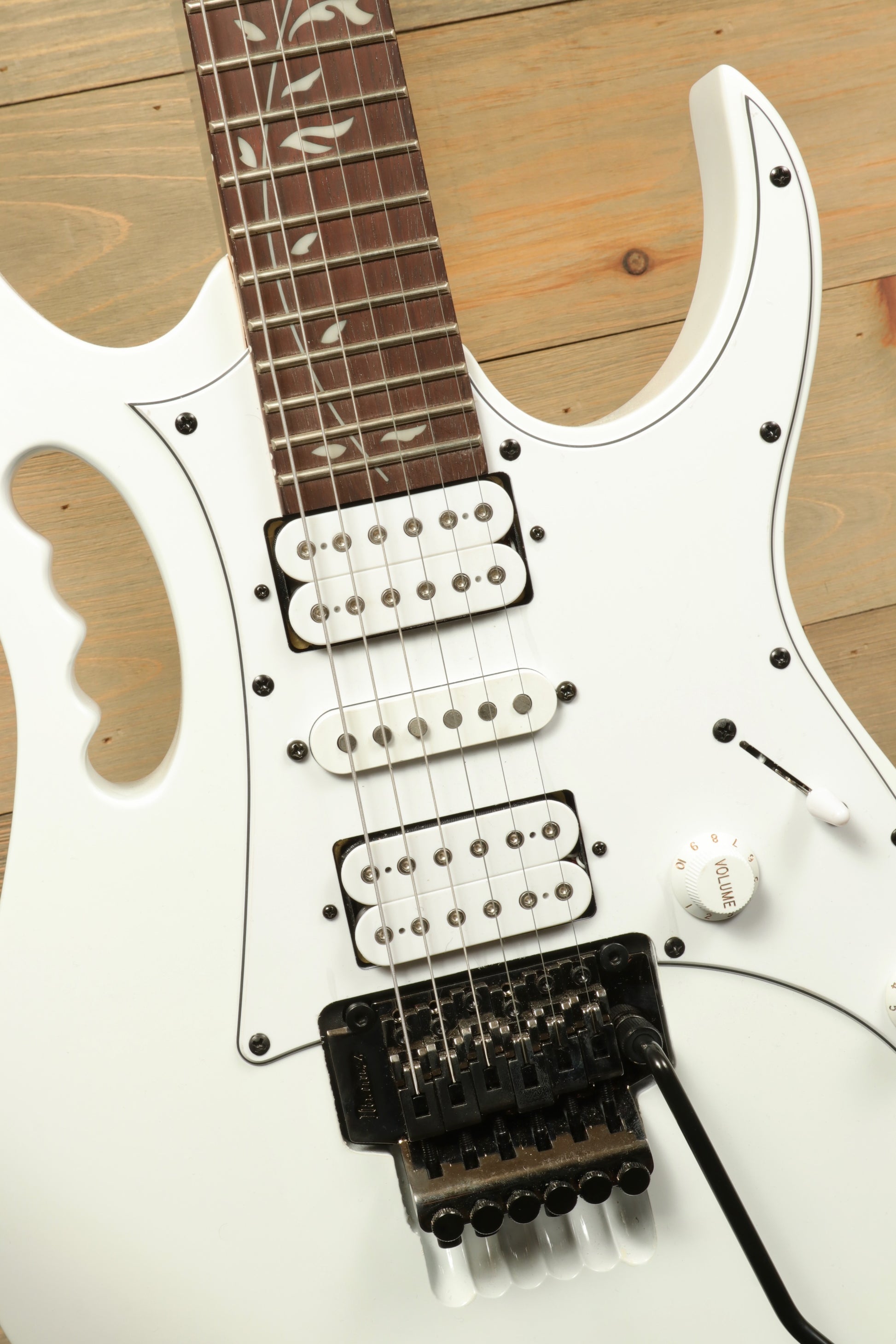 Ibanez JEMJR Steve Vai white electric guitar, front view with three pickups and stylish design