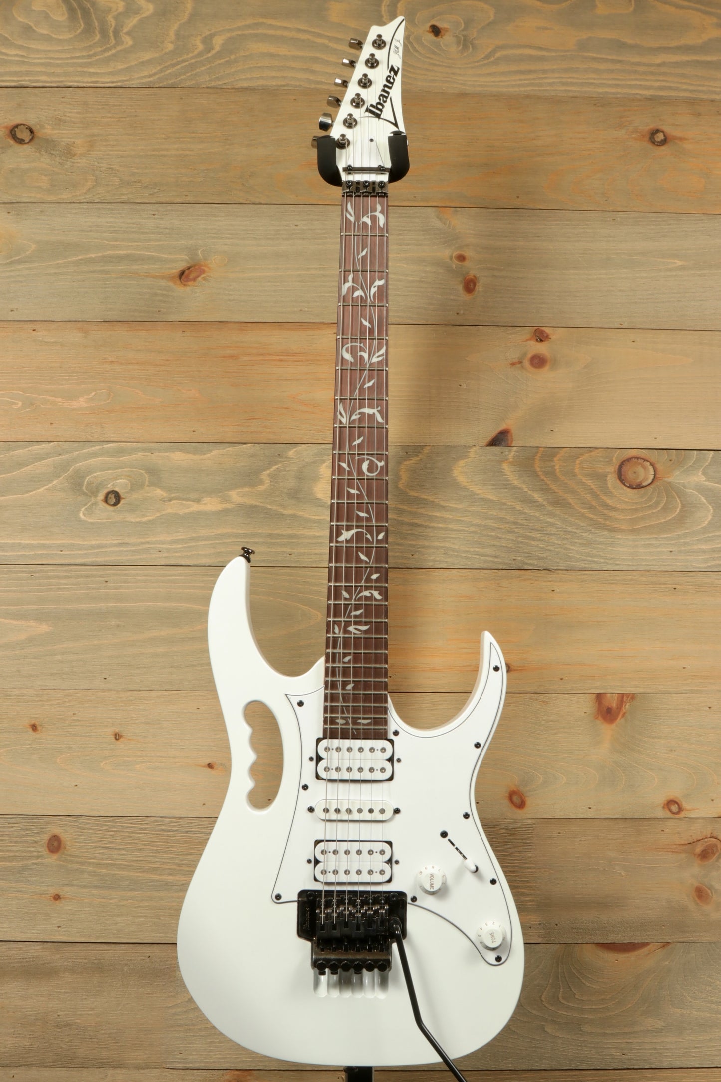 Ibanez JEMJR Steve Vai white finish electric guitar, front view with intricate fingerboard inlays