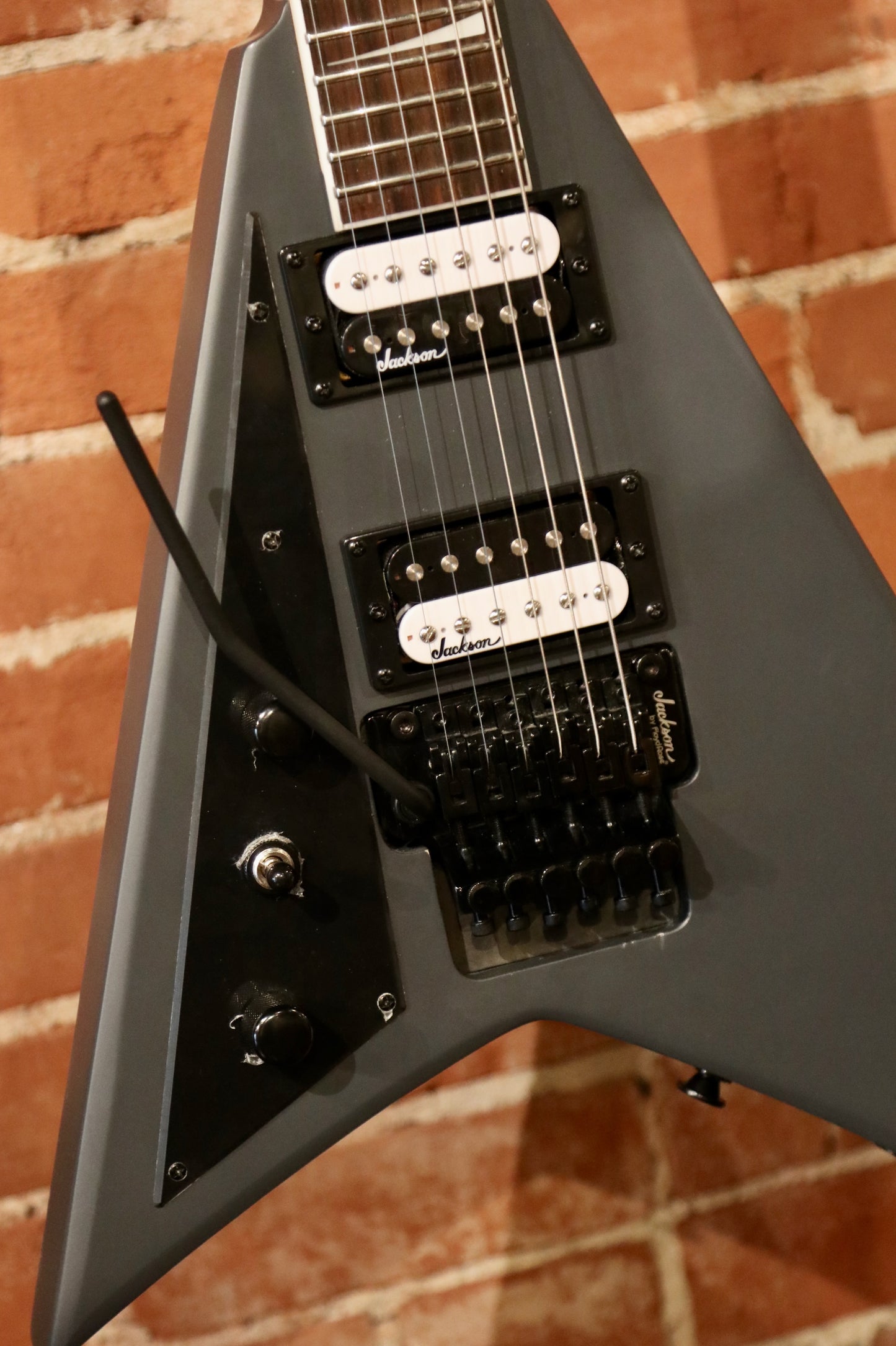 Jackson Left Handed Guitar in Satin Gray, front view with double humbuckers and control knobs
