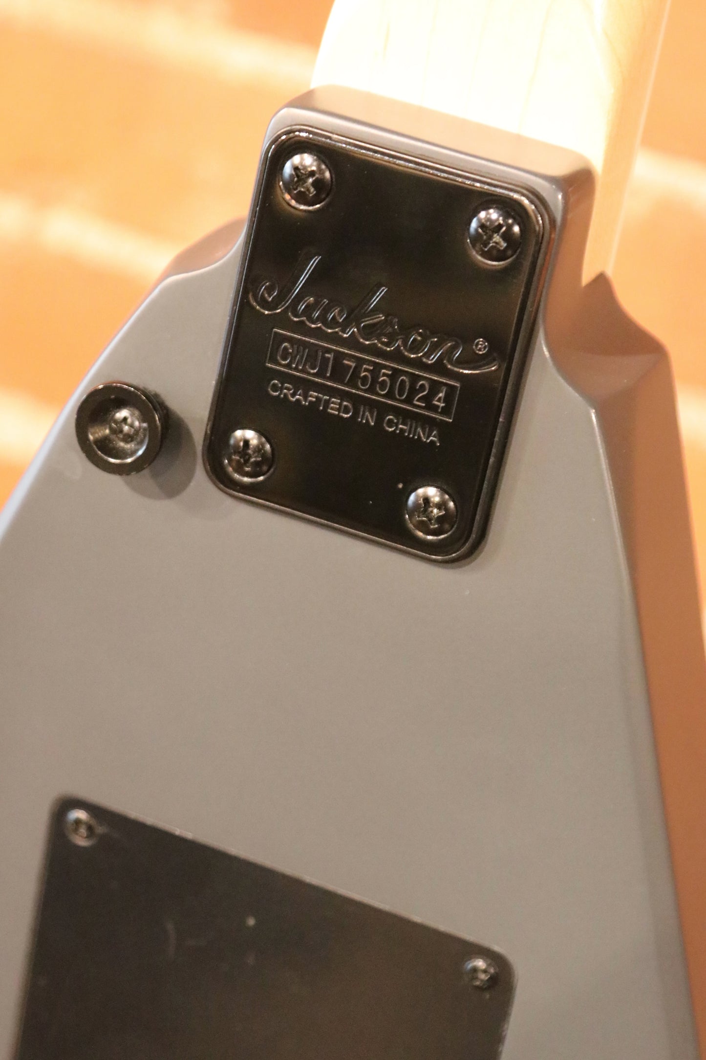 Jackson left handed guitar with a sleek gray finish, back view showcasing the craftsmanship and details