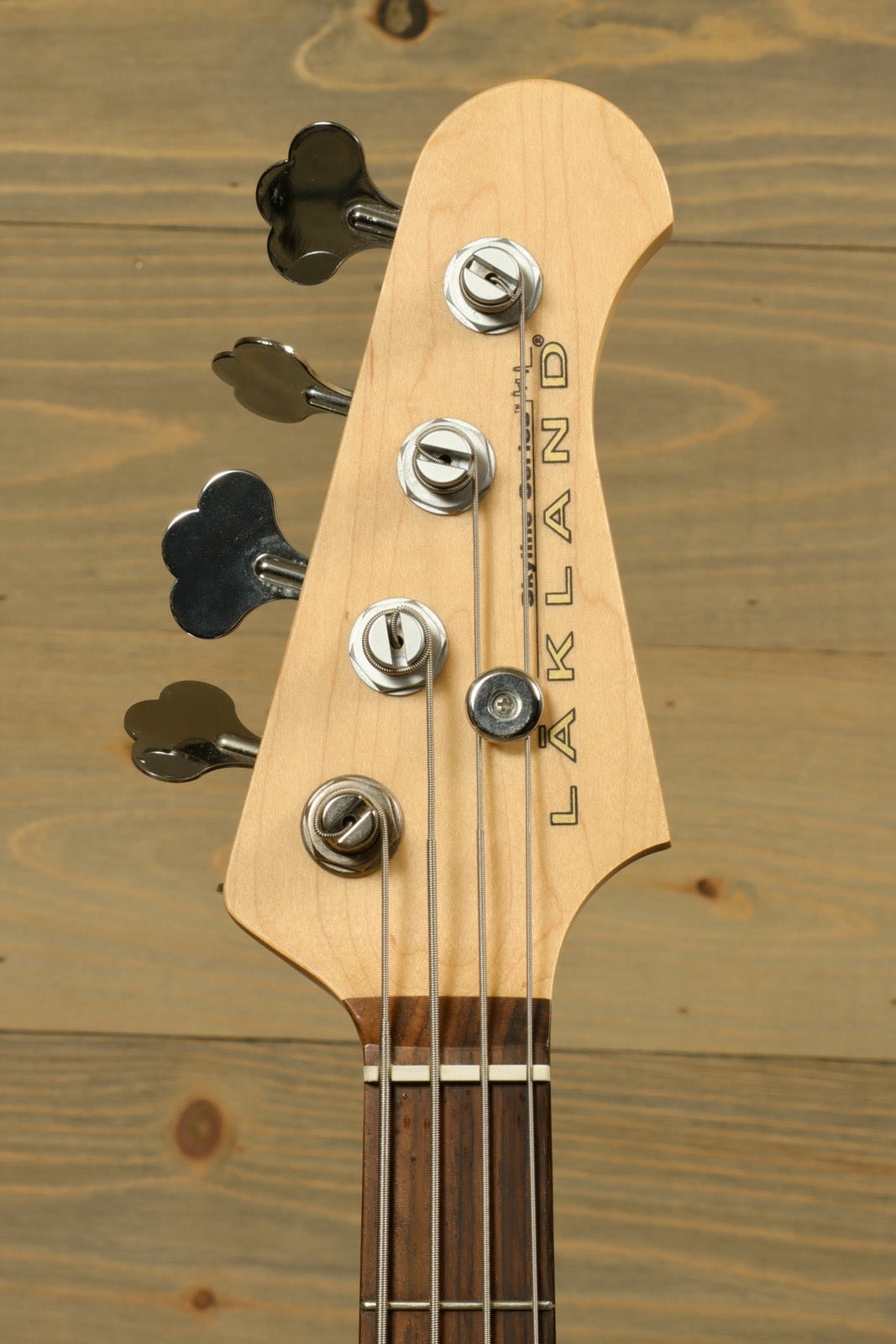 Lakland Skyline 44-01 bass guitar, natural wood finish, headstock view showcasing tuning pegs.
