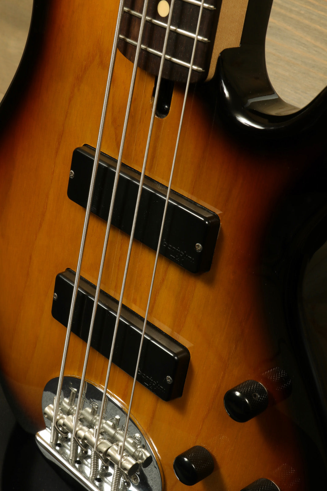 Lakland Skyline 44-01 bass guitar, sunburst finish, close-up view of pickups and controls
