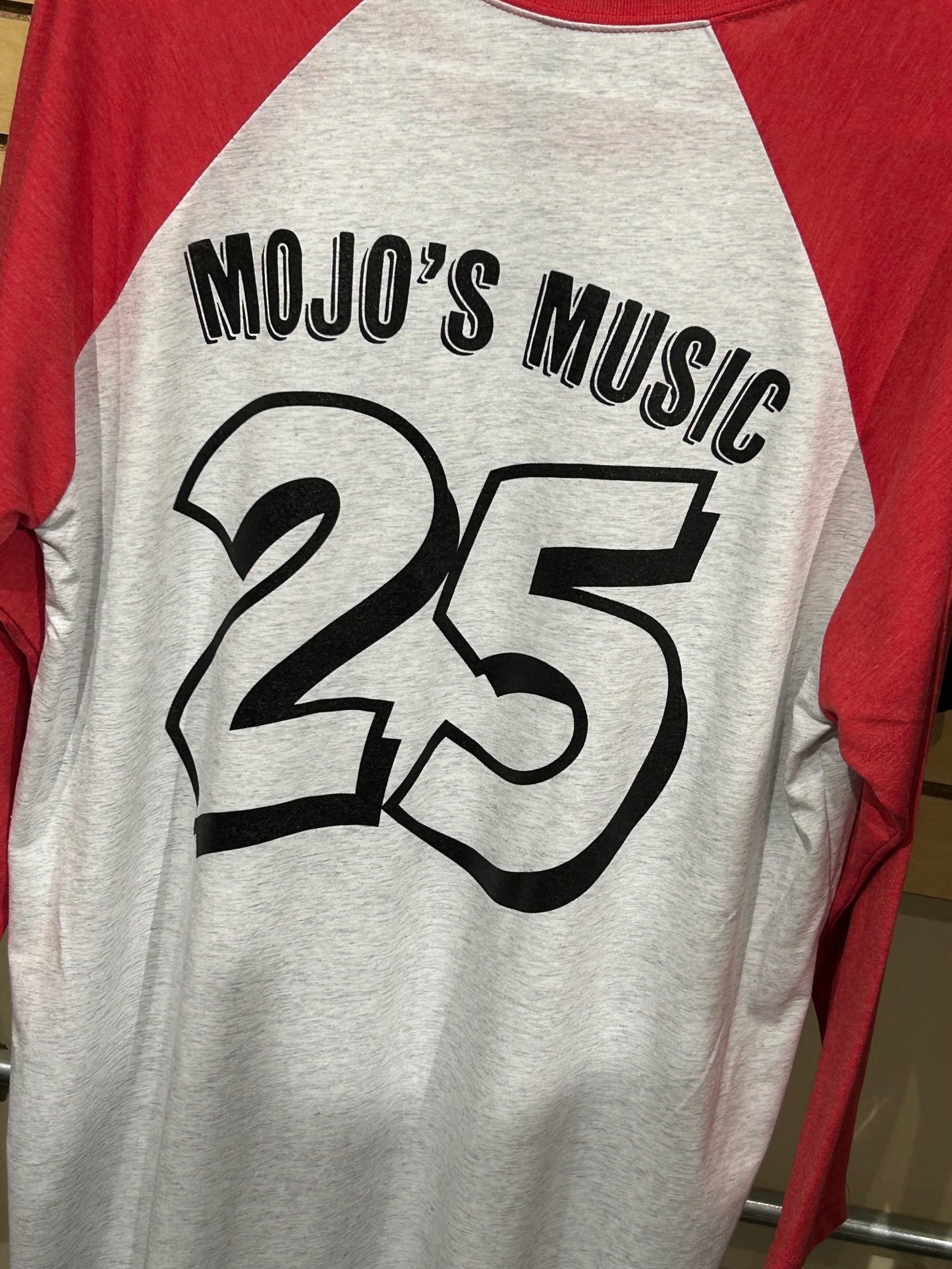 Mojo's Music 25th anniversary baseball tee featuring a bold red and gray design