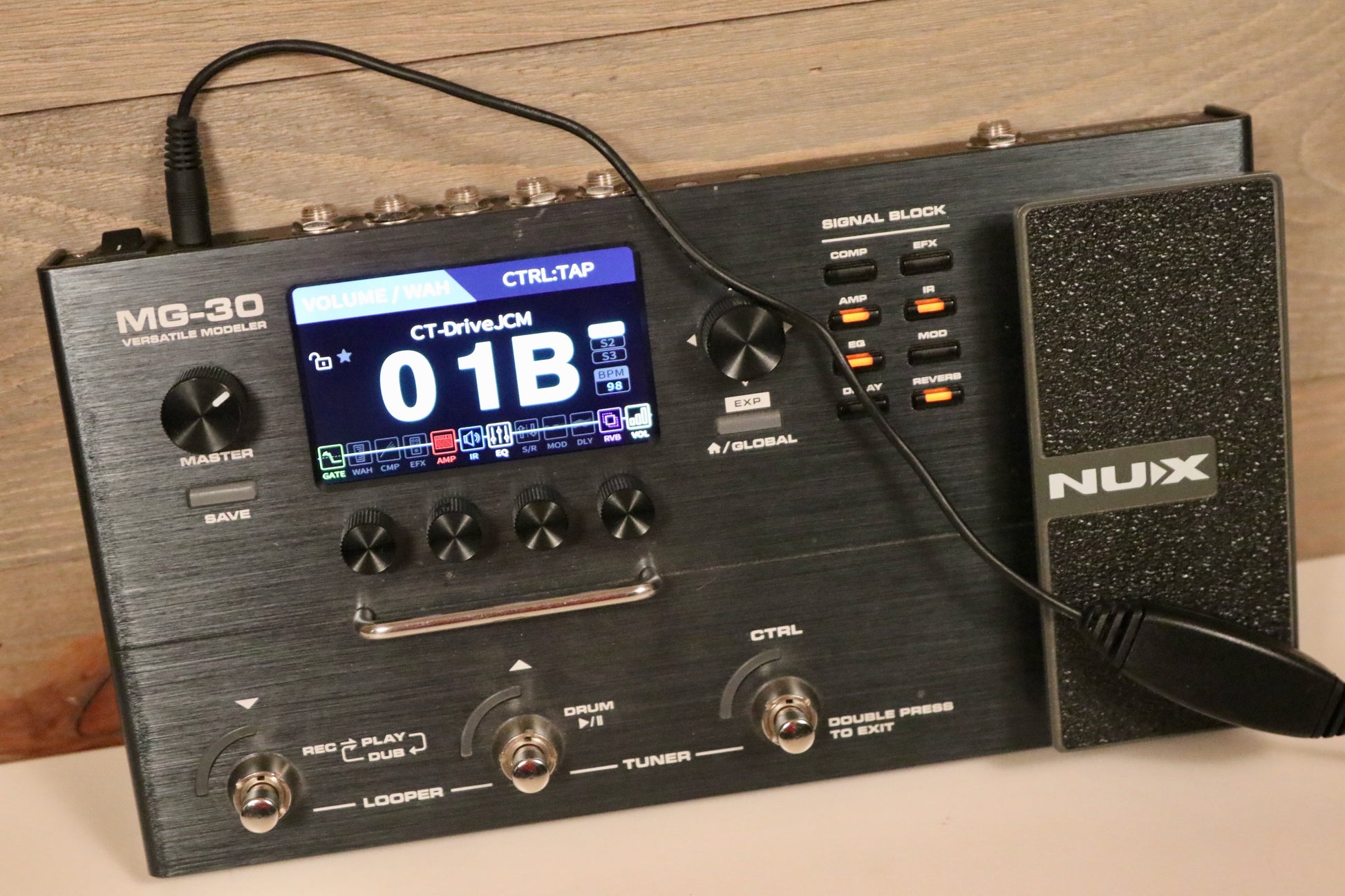 NuX MG-30 Versatile Modeling Guitar Processor in black, top view with screen and control buttons