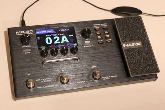 NU-X MG-30 Versatile Modeling Guitar Processor in black with display and pedal, top view