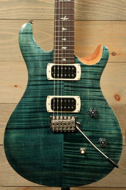 PRS electric guitar SE model in deep teal finish, front view showcasing dual pickups