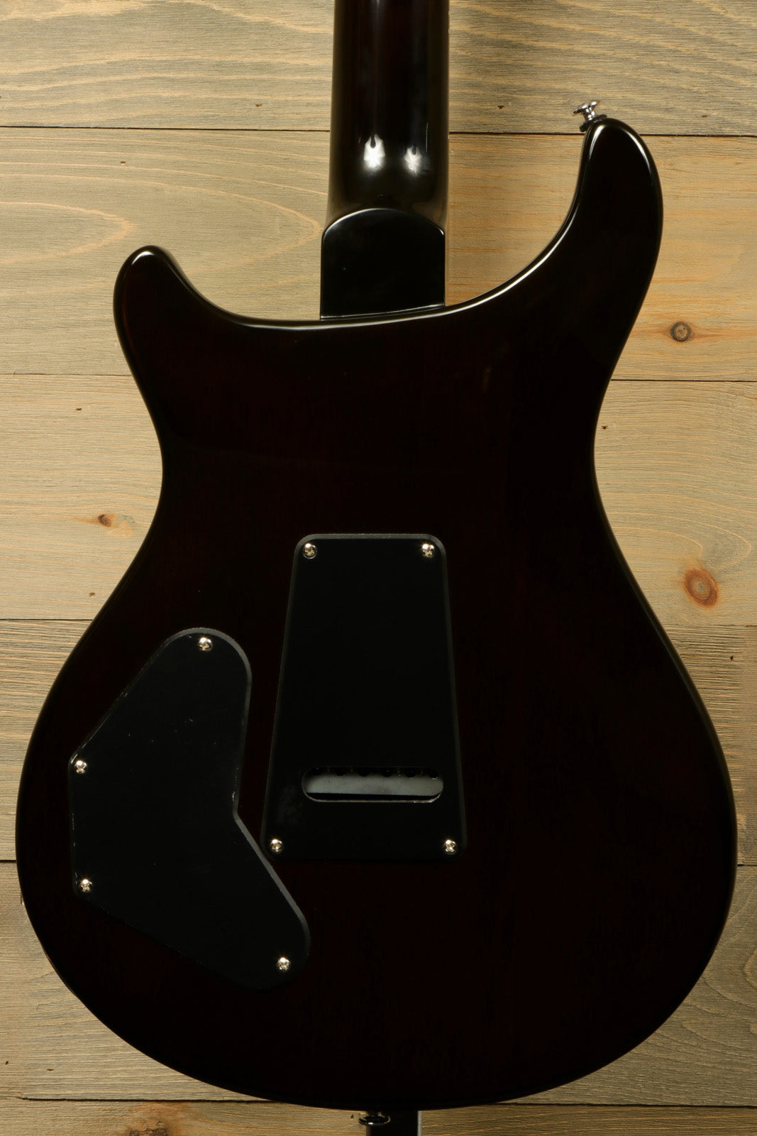 Back view of Paul Reed Smith SE DGT Sunburst with PRS Gig Bag on a wooden background