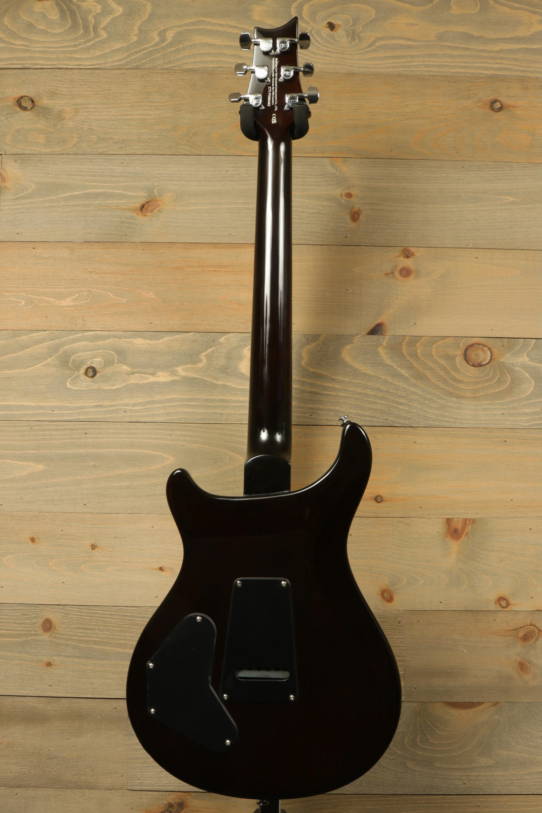 Back view of Paul Reed Smith SE DGT Sunburst with PRS Gig Bag, showcasing sleek contours and finish.