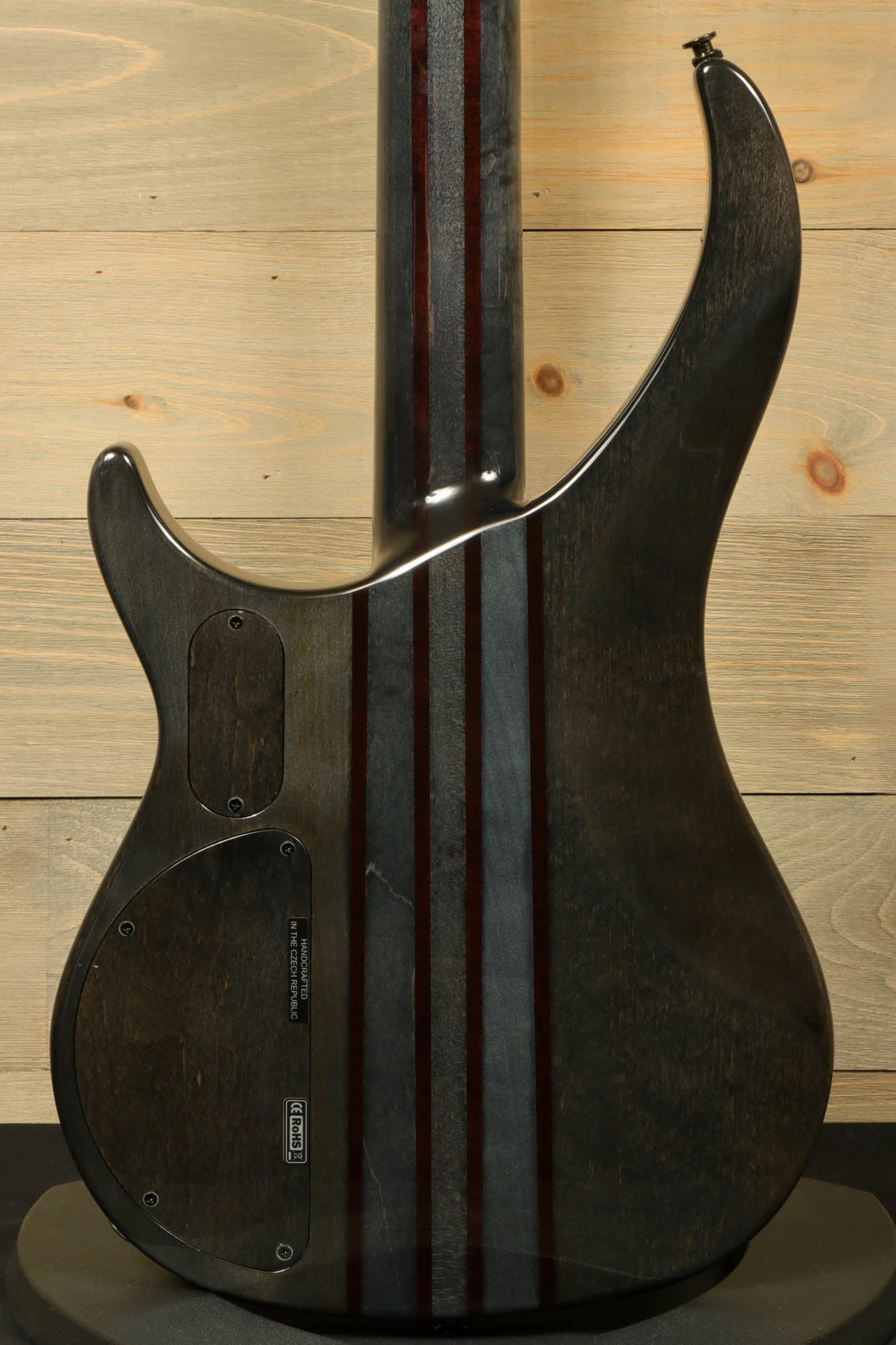 Peavey Cirrus 4 bass guitar back view showcasing the sleek finish and striped design.