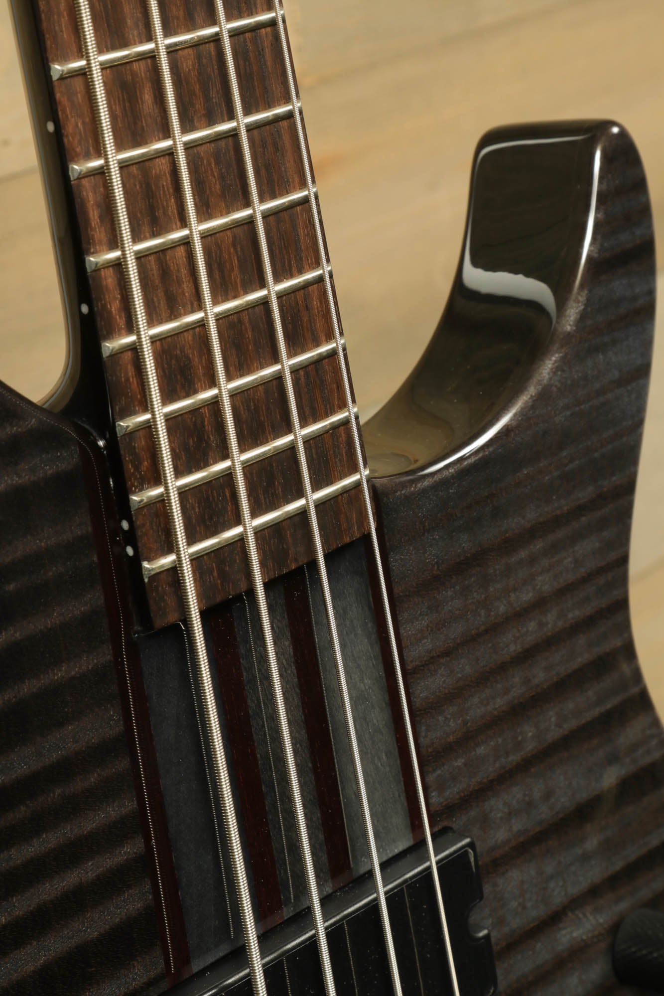 Close-up of Peavey Cirrus 4 bass guitar showing sleek neck and fretboard details