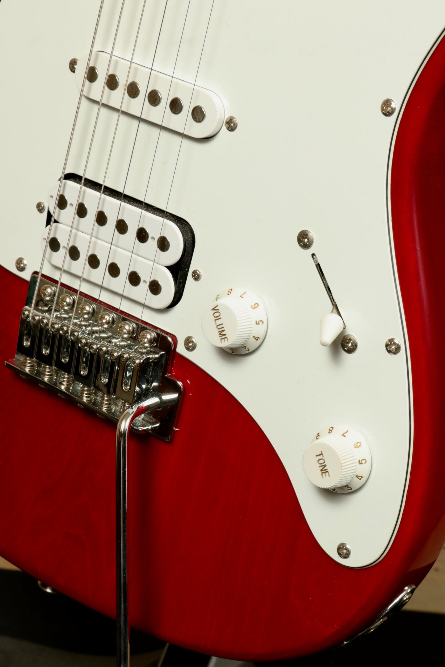 Close-up of the Peavey Raptor Plus - USED electric guitar with white pickguard and control knobs