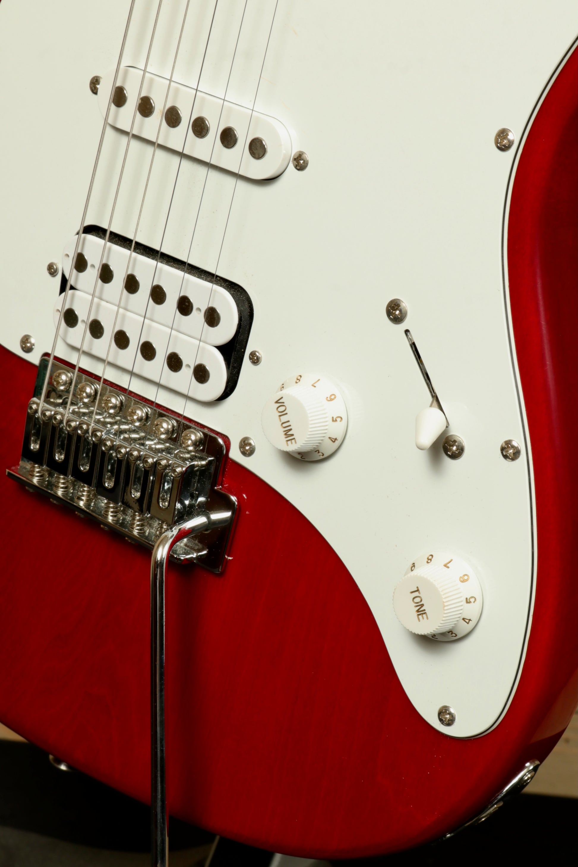 Close-up of the Peavey Raptor Plus - USED electric guitar with white pickguard and control knobs