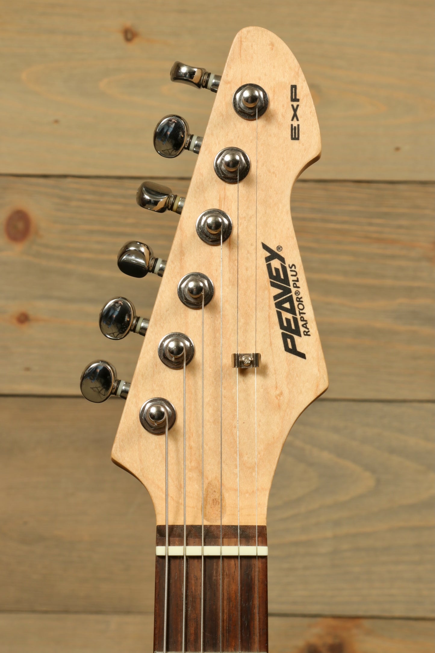 Close-up of Peavey Raptor Plus - USED electric guitar headstock with tuning pegs