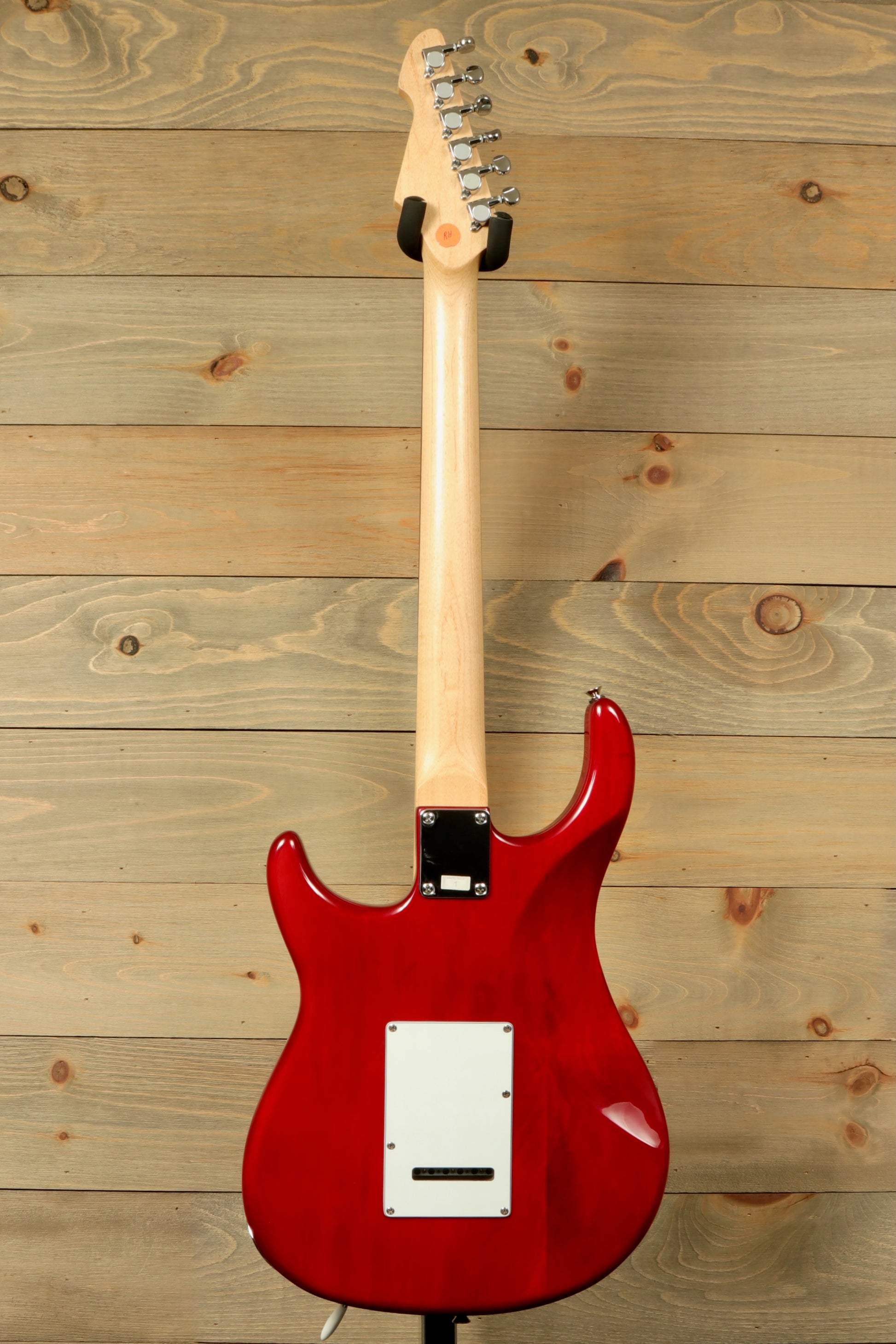 Back view of a used Peavey Raptor Plus electric guitar showcasing its sleek red finish and smooth contours
