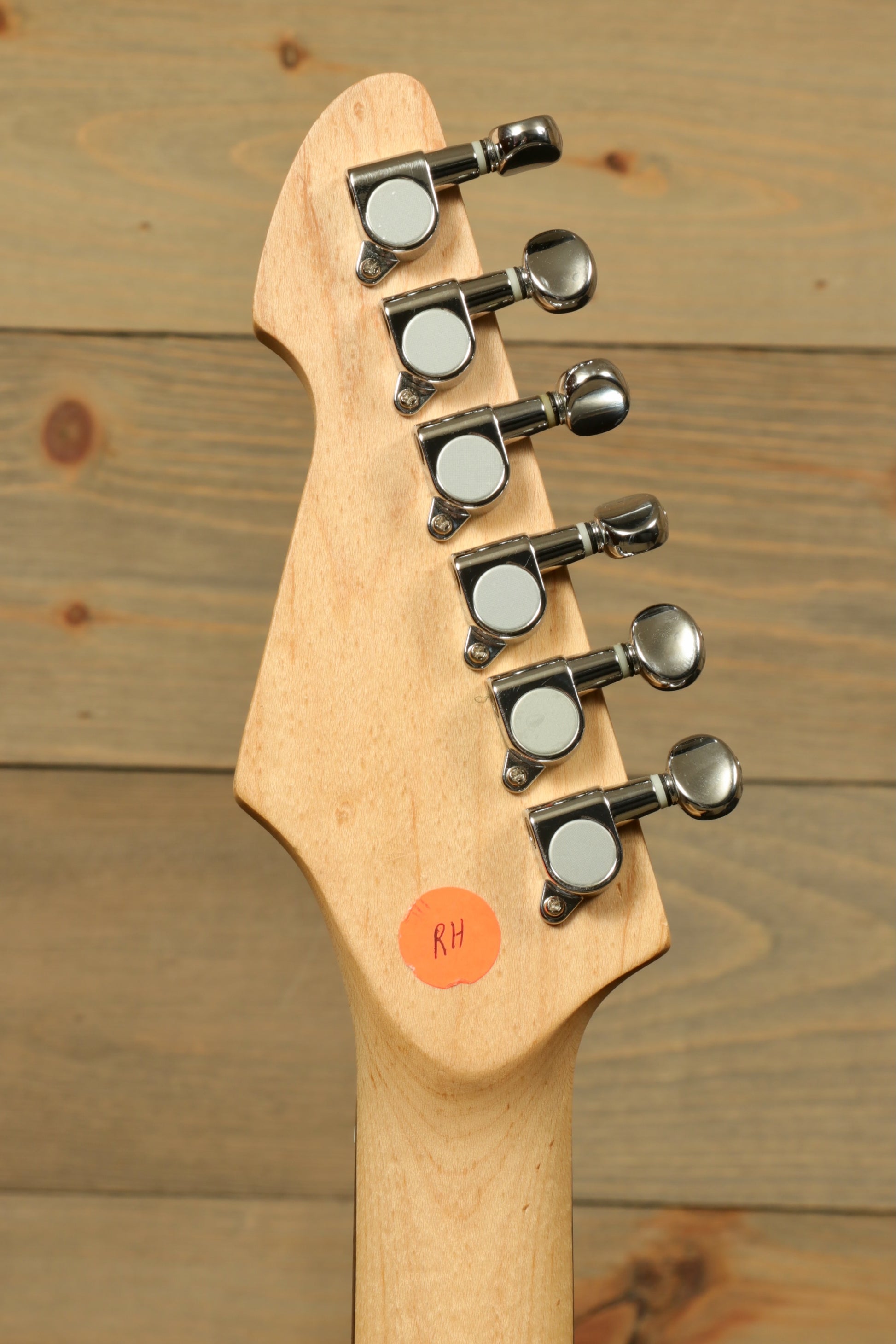 Peavey Raptor Plus - USED electric guitar headstock featuring tuning pegs and natural wood finish