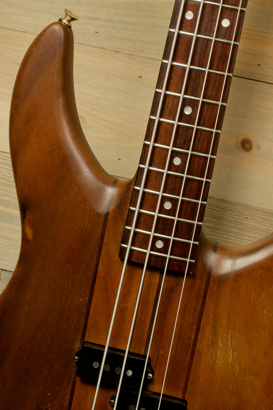 Vintage Peavey Unity Koa Bass with a natural wood finish, top view showcasing the neck and fretboard