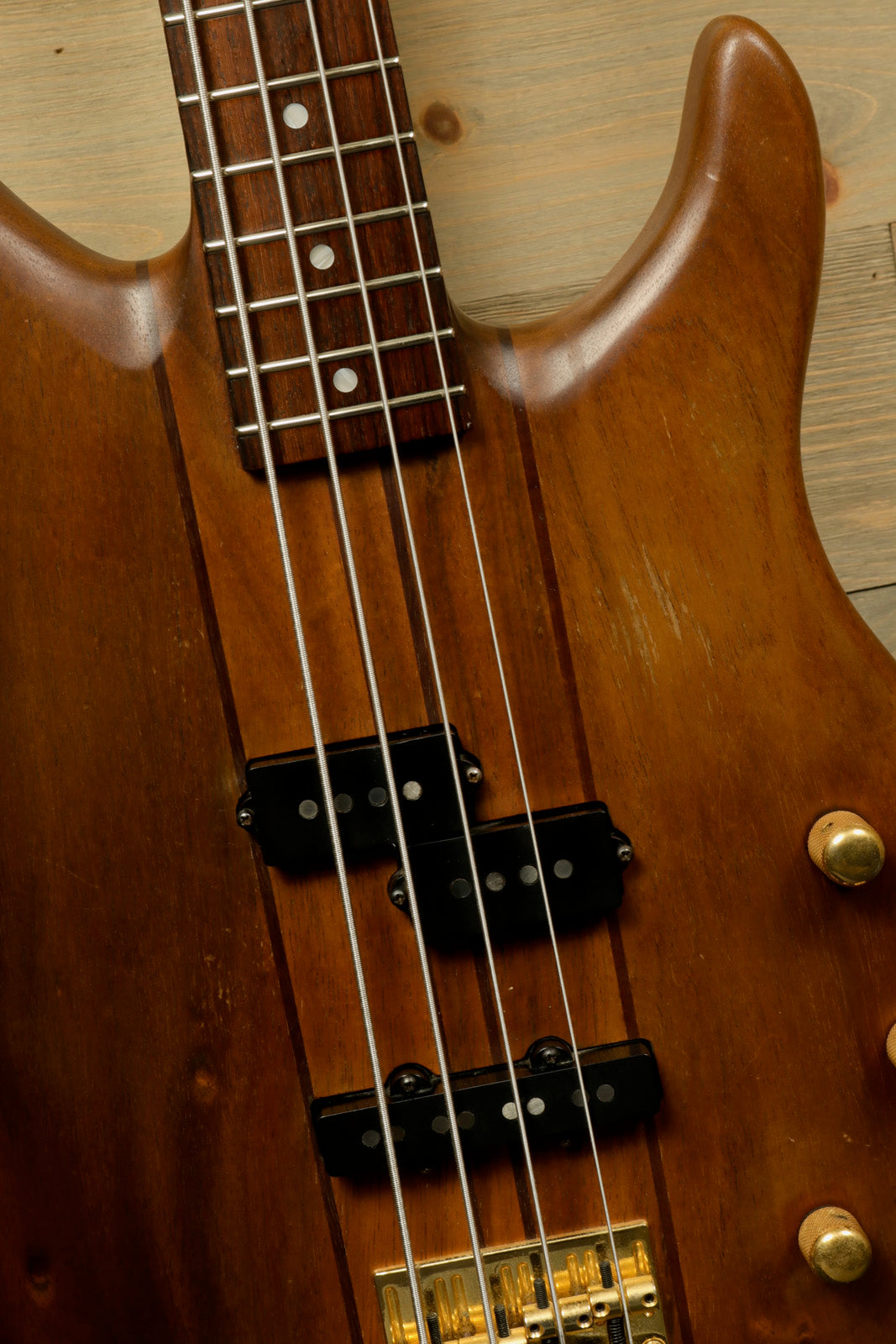 Peavey Vintage Peavey Unity Koa Bass in natural wood finish, close-up view of body and neck
