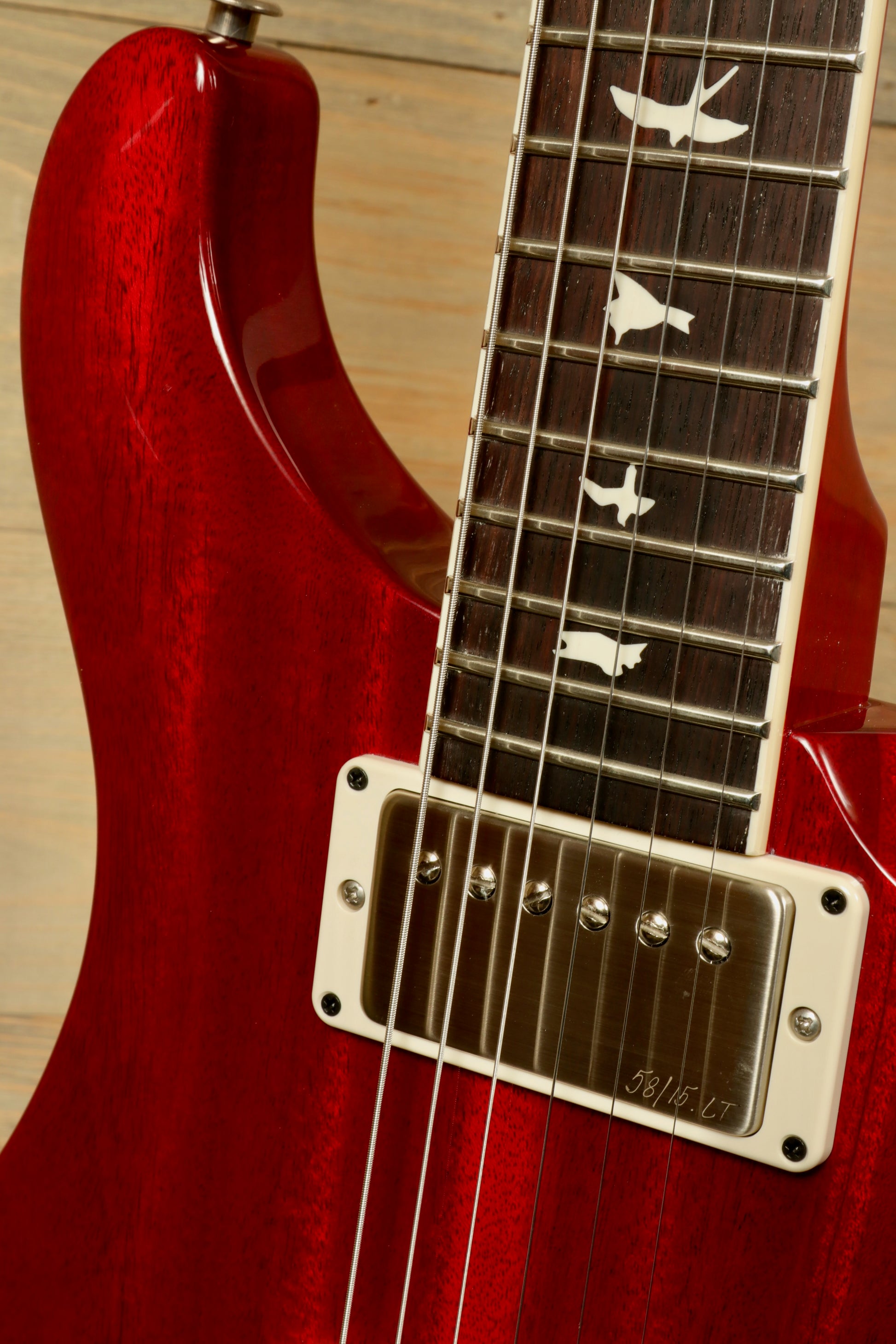 Close-up of PRS 594 McCarty Electric Guitar showcasing its rich red finish and intricate neck inlays