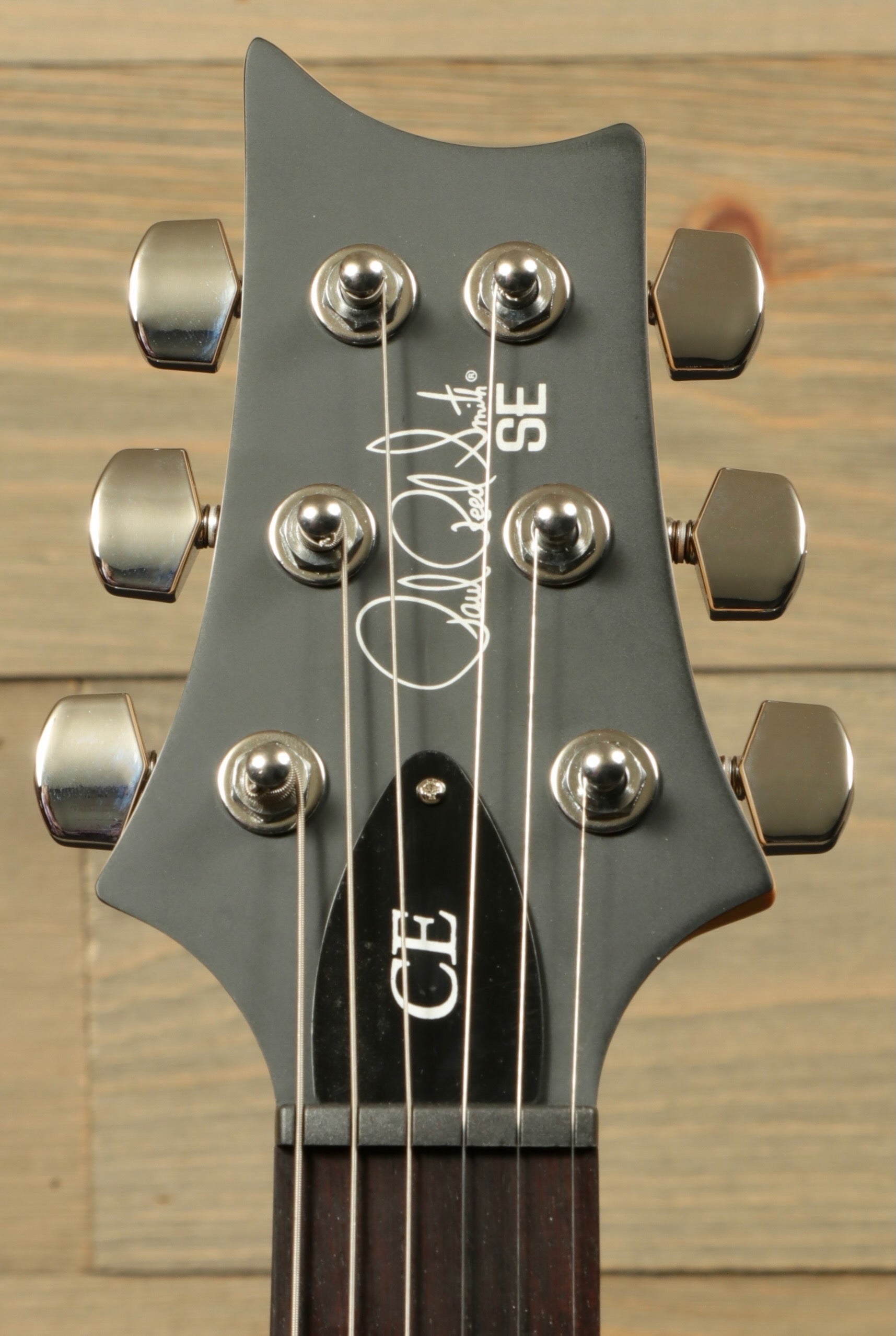 PRS SE CE24 electric guitar headstock featuring signature and chrome tuning pegs