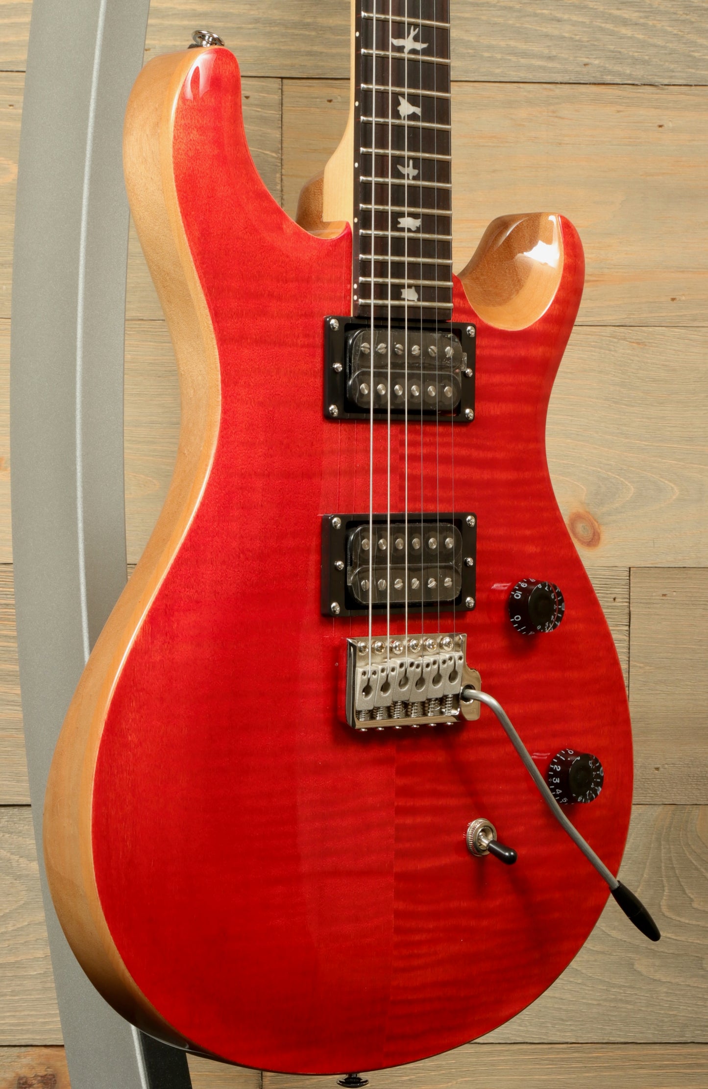 PRS SE CE24 electric guitar in vibrant red finish with dual pickups and sleek design for musicians