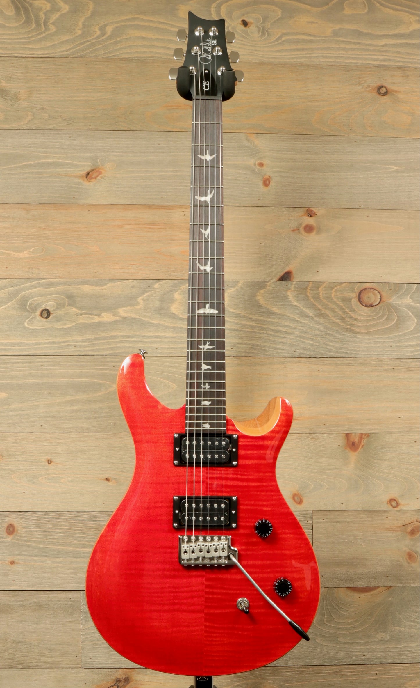 PRS SE CE24 electric guitar in Red with a sleek design and versatile sound features