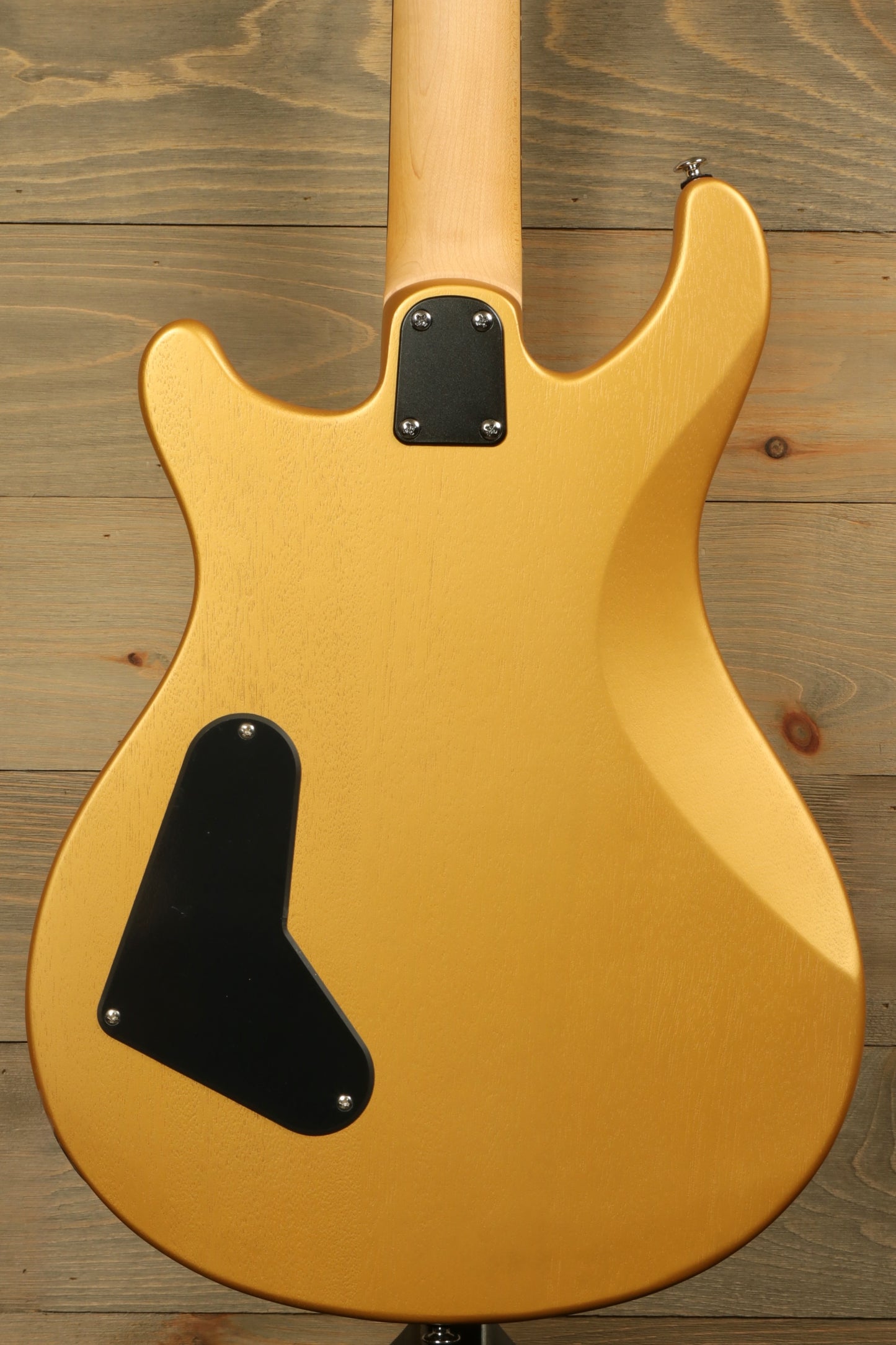 Back view of PRS SE CE24 Standard Stoptail guitar in gold finish highlighting its sleek design