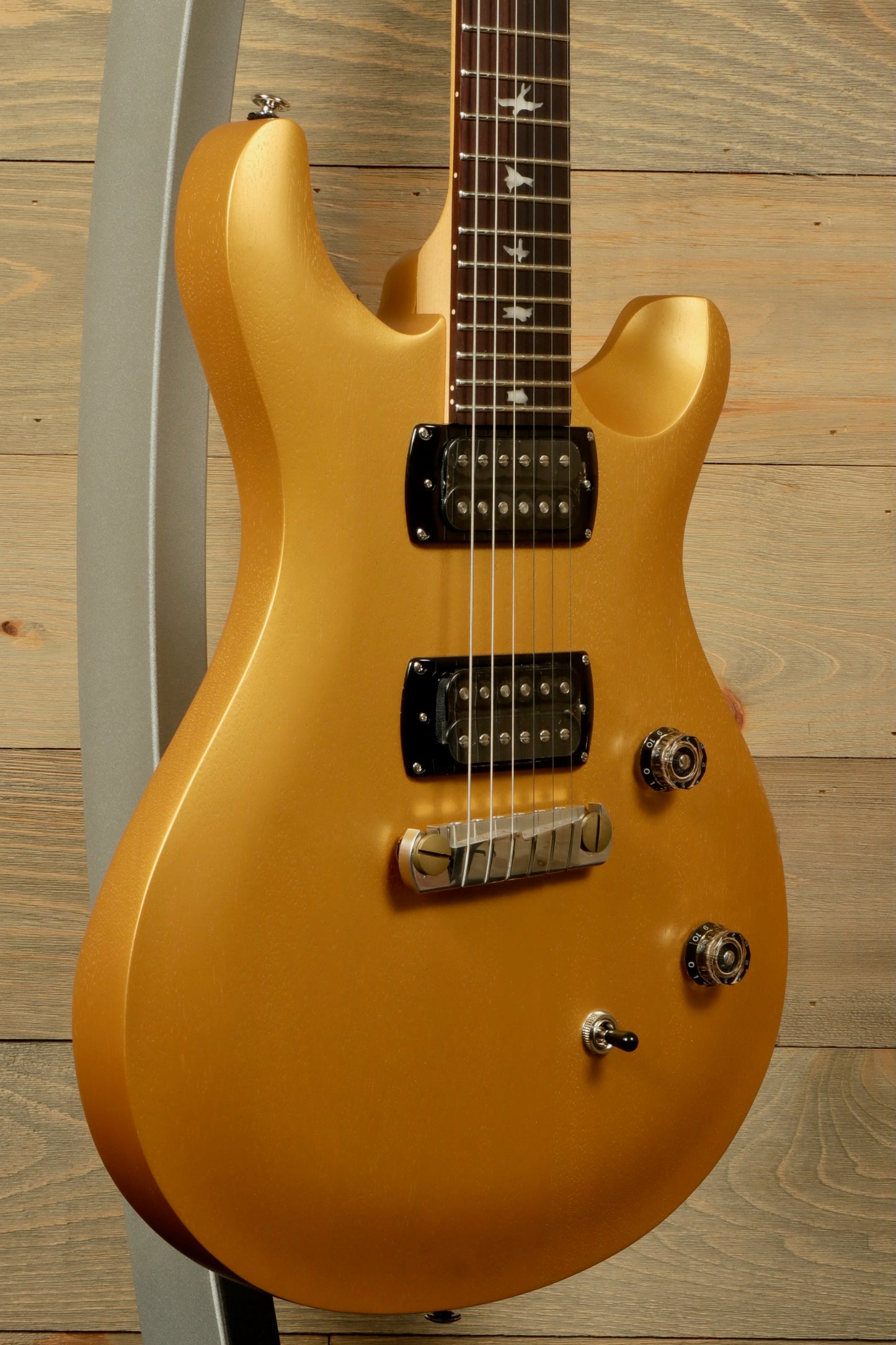 PRS SE CE24 Standard Stoptail guitar in gold finish with sleek body design and dual pickups