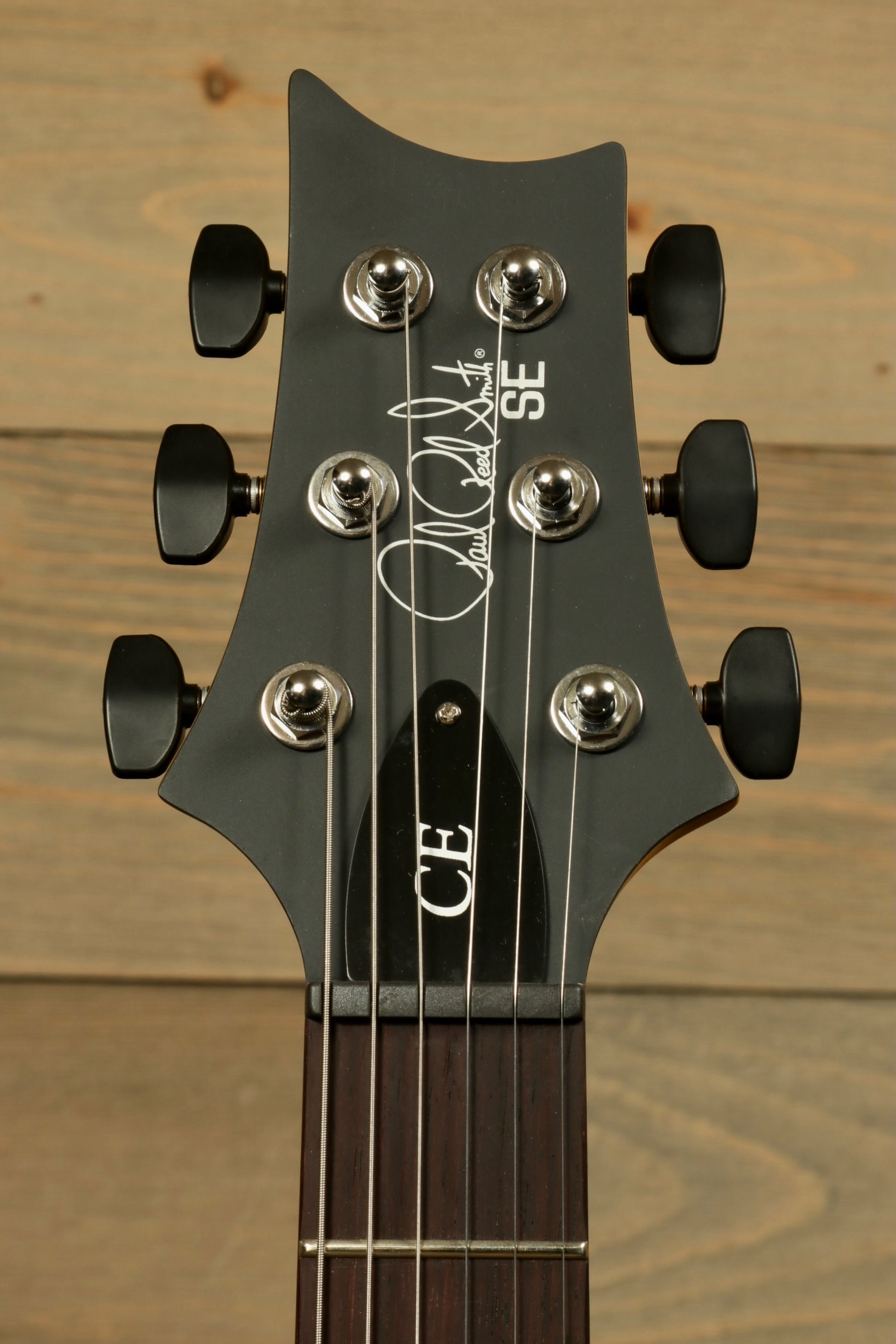 PRS SE CE24 Standard Stoptail guitar headstock featuring signature and tuning pegs