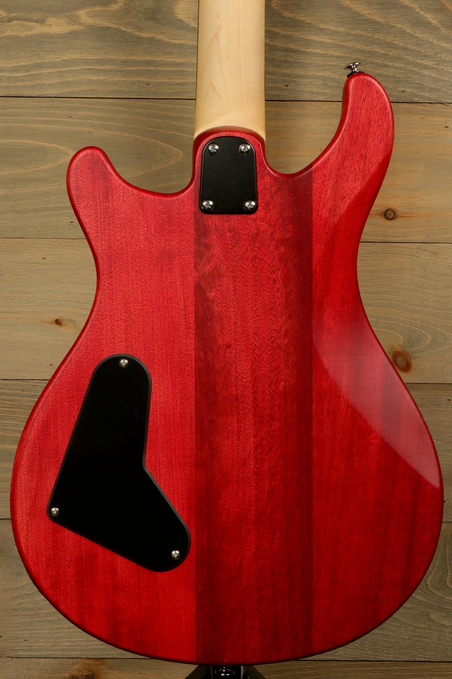 Back view of the PRS SE CE24 Standard Stoptail guitar in a vibrant red finish with smooth contours